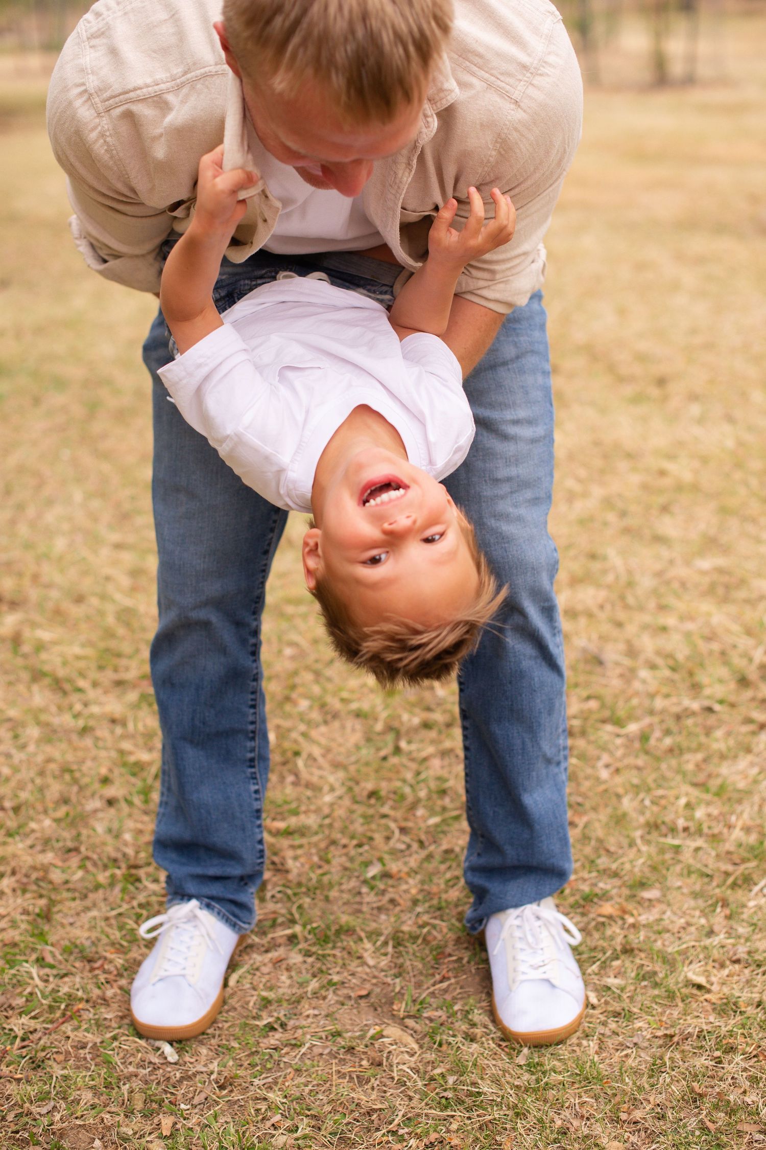 Family photography, Father and son playing  idea, true to life colors, spring  apple orchard at Rogers Grove, Longmont, by Angelice Caballer