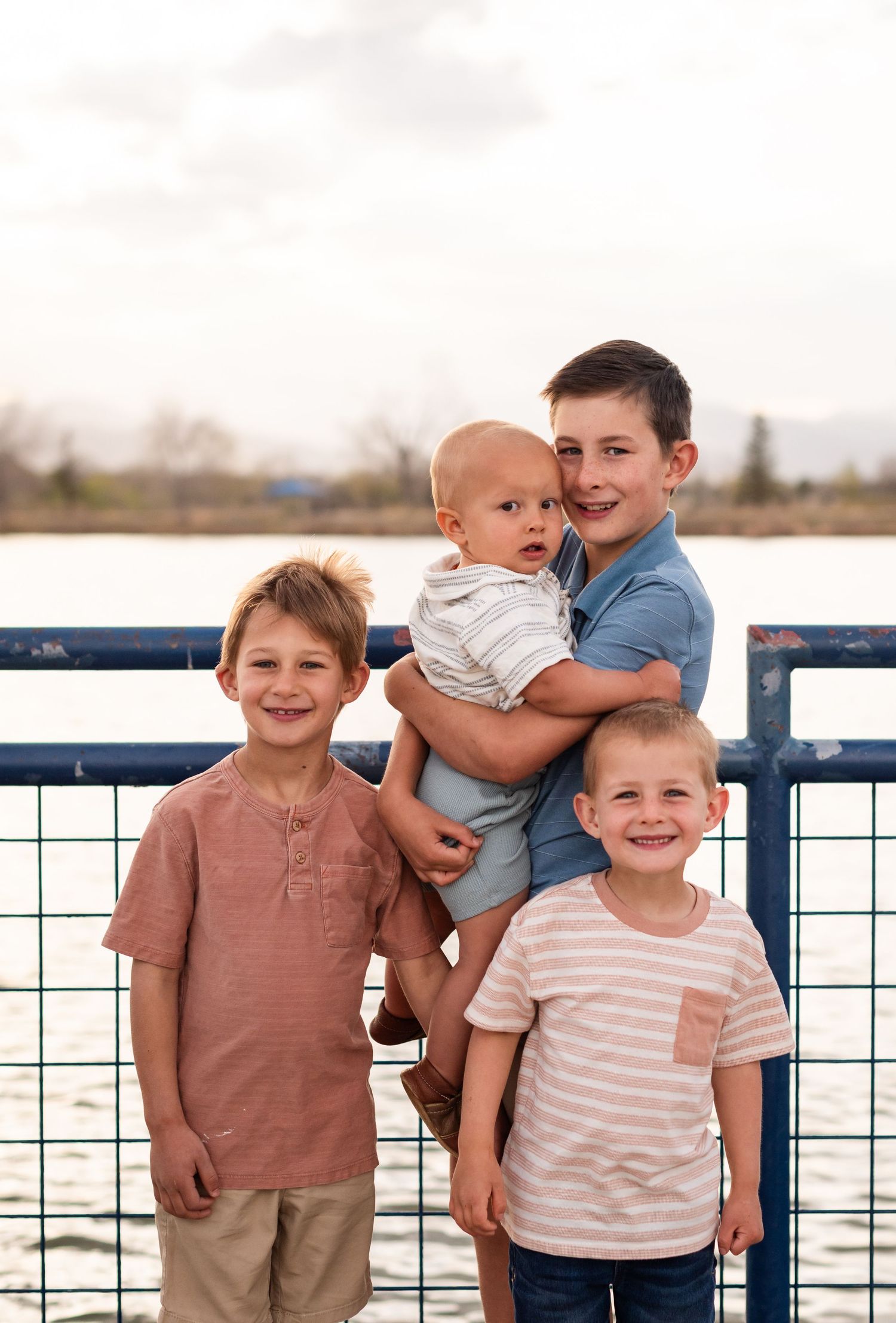Family photography playful ideas brothers pose  on the pier at Golden Ponds, Longmont Co photography true-to-life by Angelice Caballler