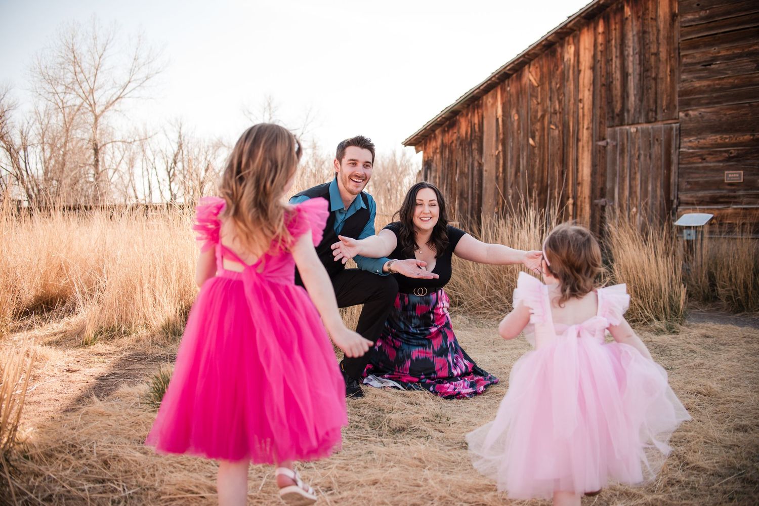 Family Photography at Sandstone Ranch, Longmont, CO. Playful pose idea, children running to parents for family photo sessions