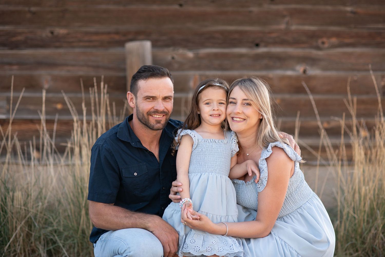 Family photography, pose near barn idea, true to life colors, spring blue at Sandstone Ranch, Longmont by Angelice Caballer