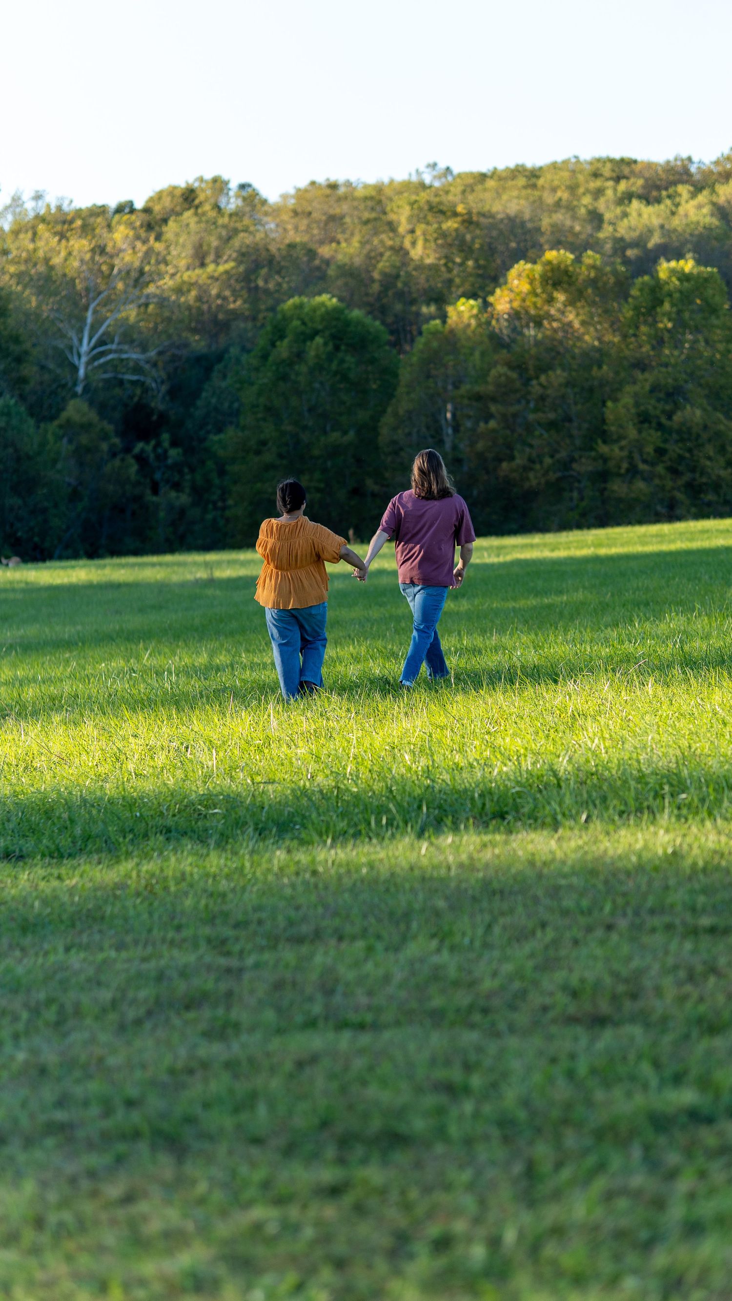 Couple Engagement photoshoot at Jerusalem Mill in Joppa Maryland. Running in a field