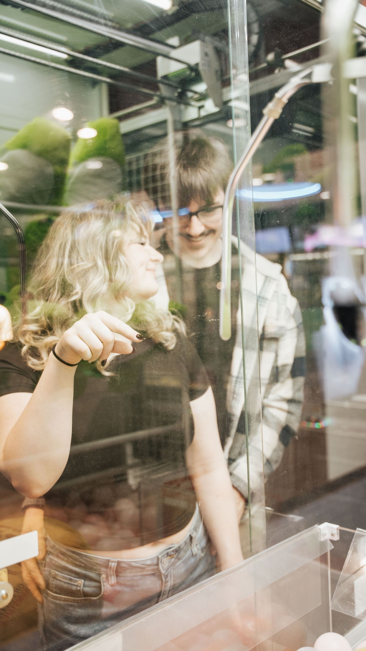 Romantic couple sharing a tender moment together near a claw machine at an arcade. In Towson Maryland