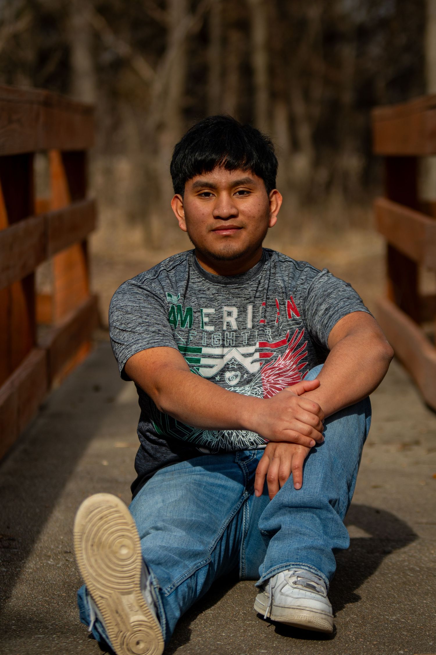 Senior photo session for high school graduate on a bridge at Hall County Park