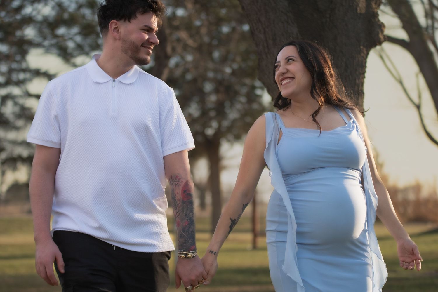 Couple holding hand during maternity session taken at Hall County Park in Grand Island Nebraska.
