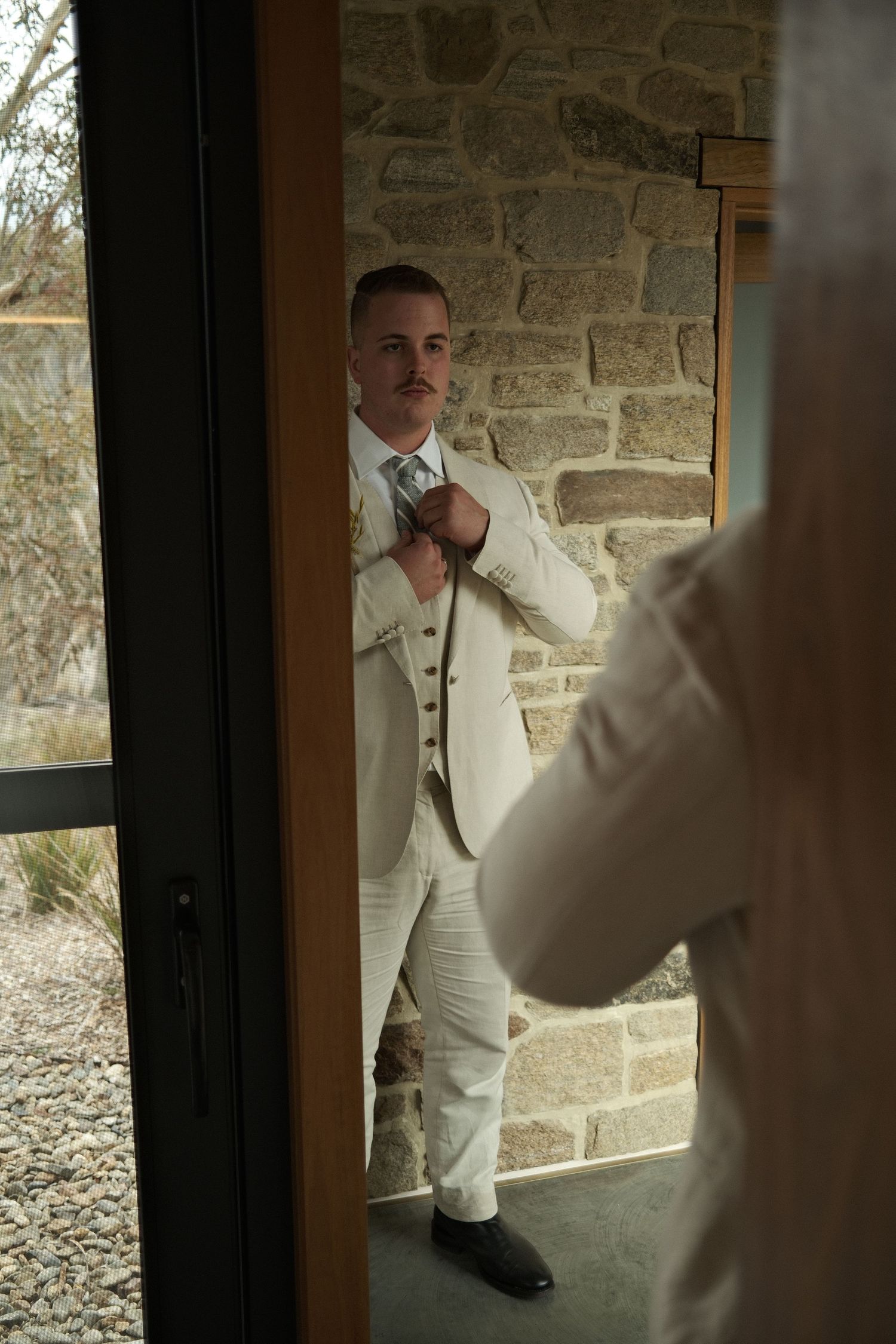 Groom getting ready in the snowy moutains australian wedding and elopement photographer Shae Imagery in Crakenback NSW Crafters Cabin