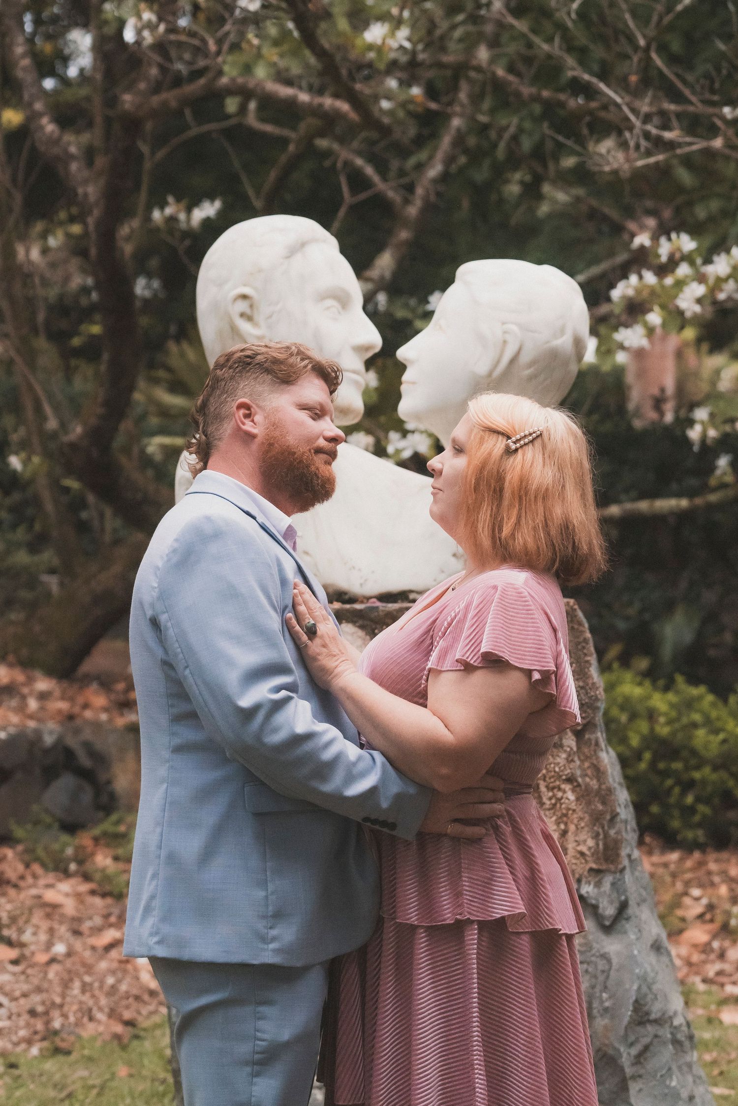 Bride and groom embracing during their surprise vow renewal at Noosa Botanical Gardens, captured by a Sunshine Coast documentary photographe