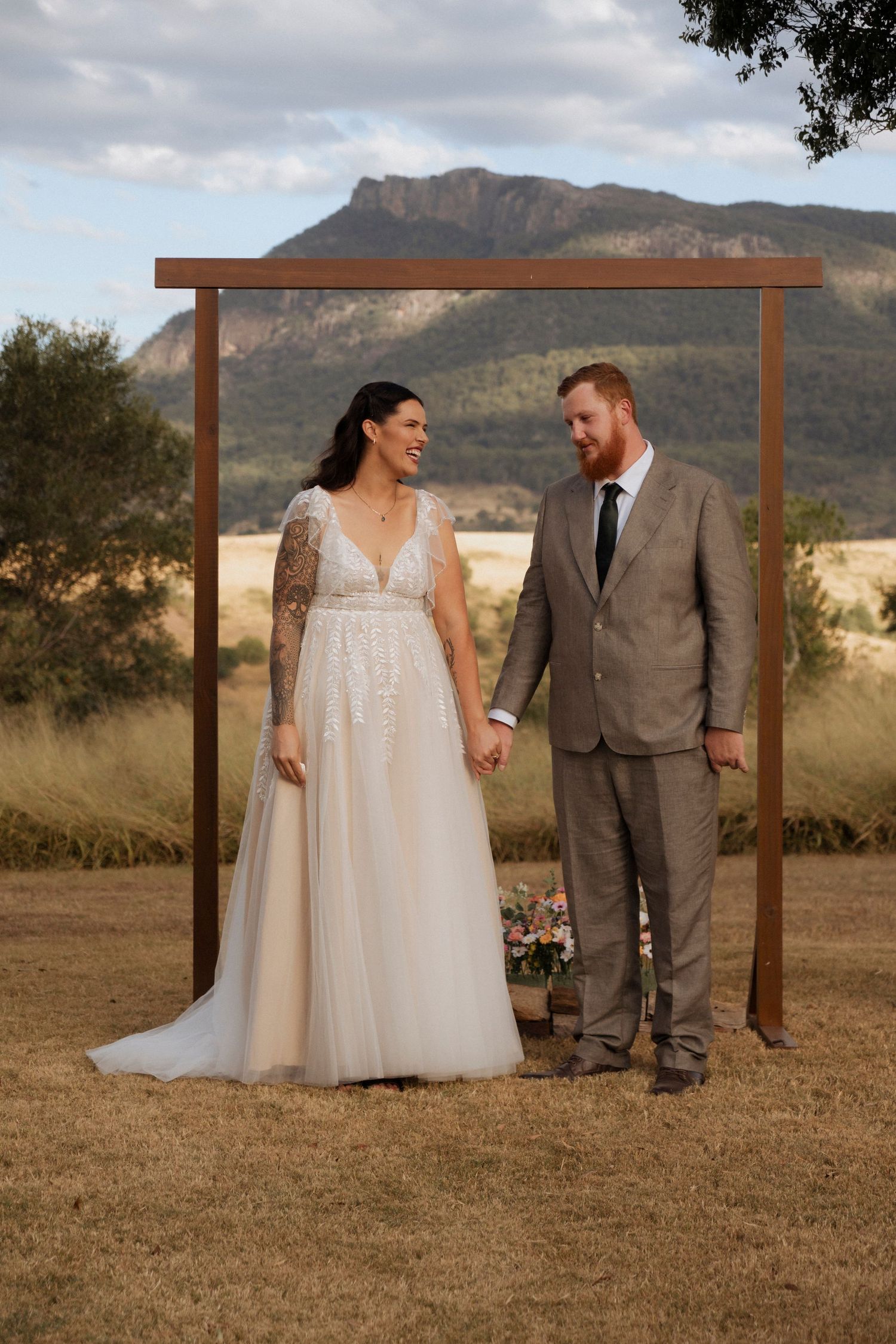 bride and groom under simple alter at Maroon Hill estate amazing views fro ceremony location of Maroon Mountain scenic rim wedding photos