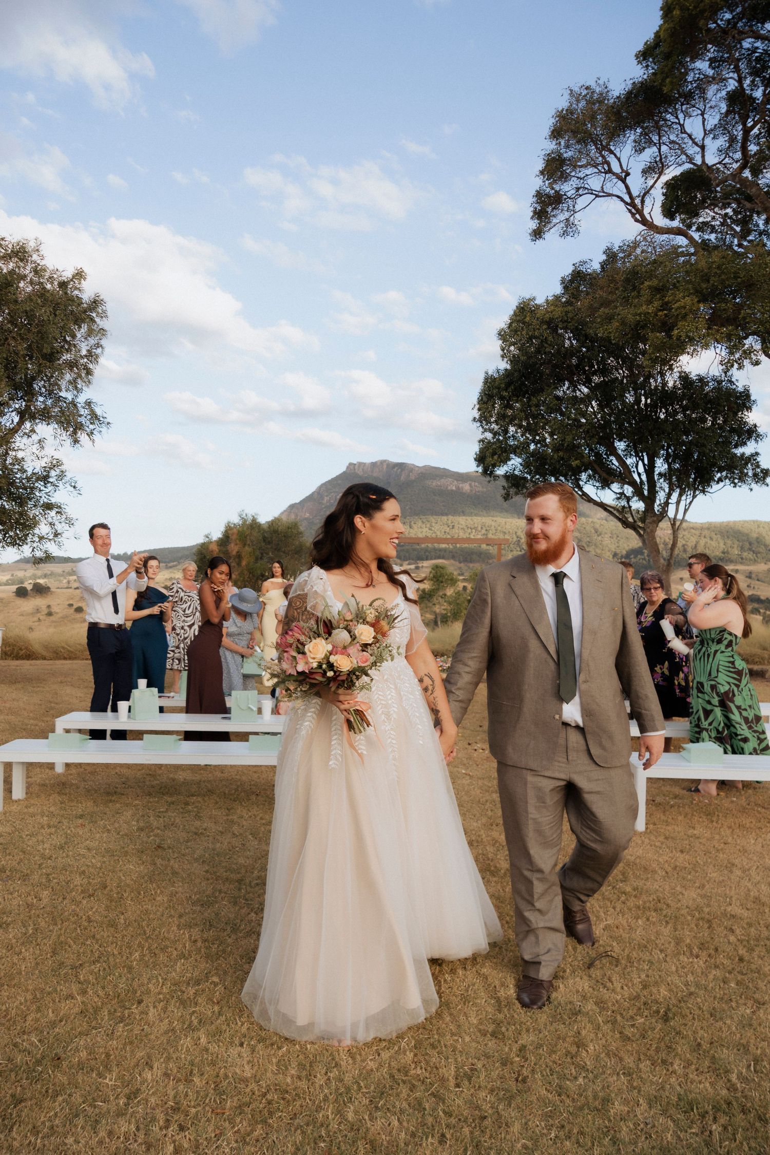 Bride and Groom Aisle exits at Maroon hill estate, family and friends in the background with mountain views country wedding photography