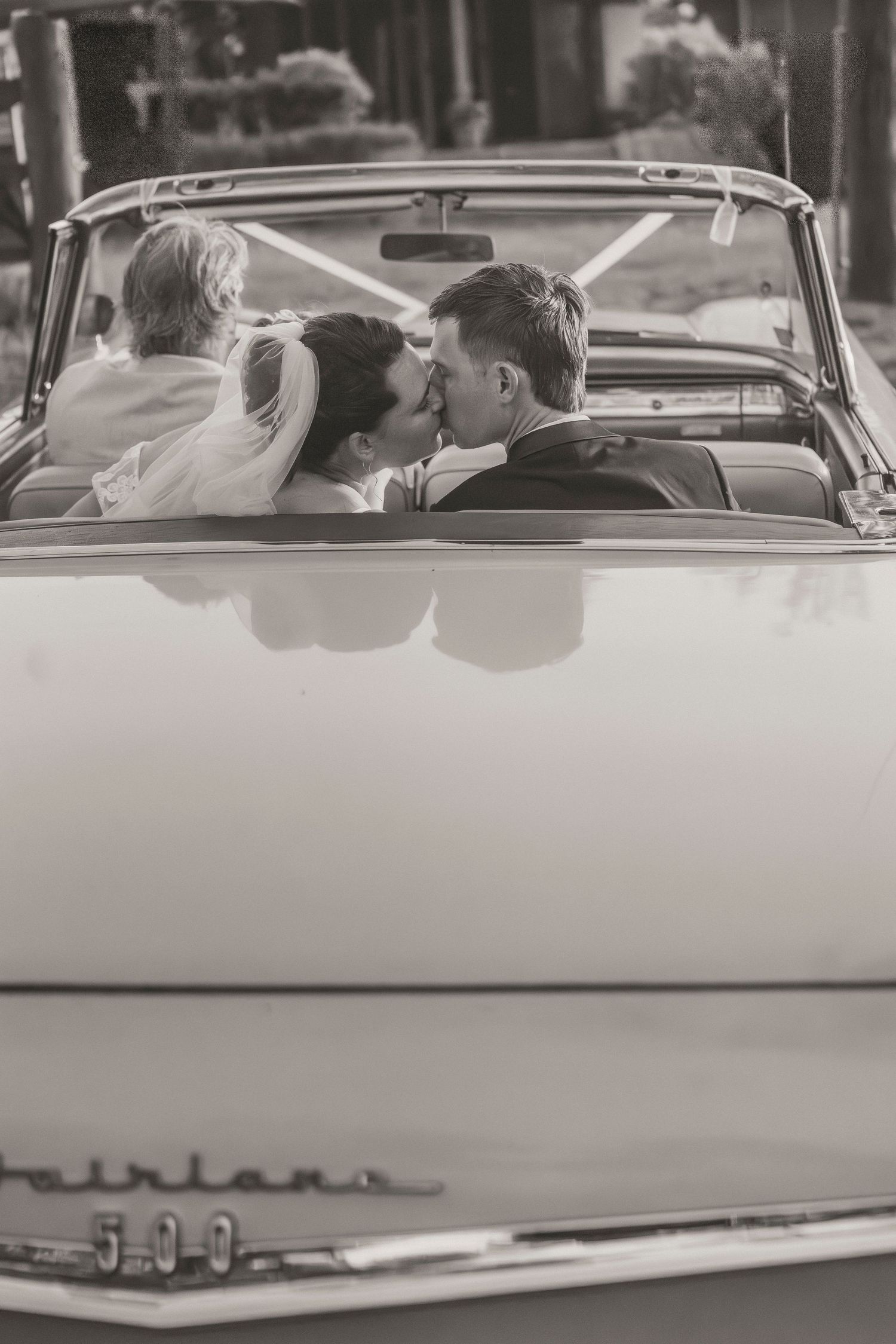 Bride and groom in getaway car at Lockyer Valley wedding.  book 2026 and 2027 wedding dates now. Cinematic editorial wedding photographer