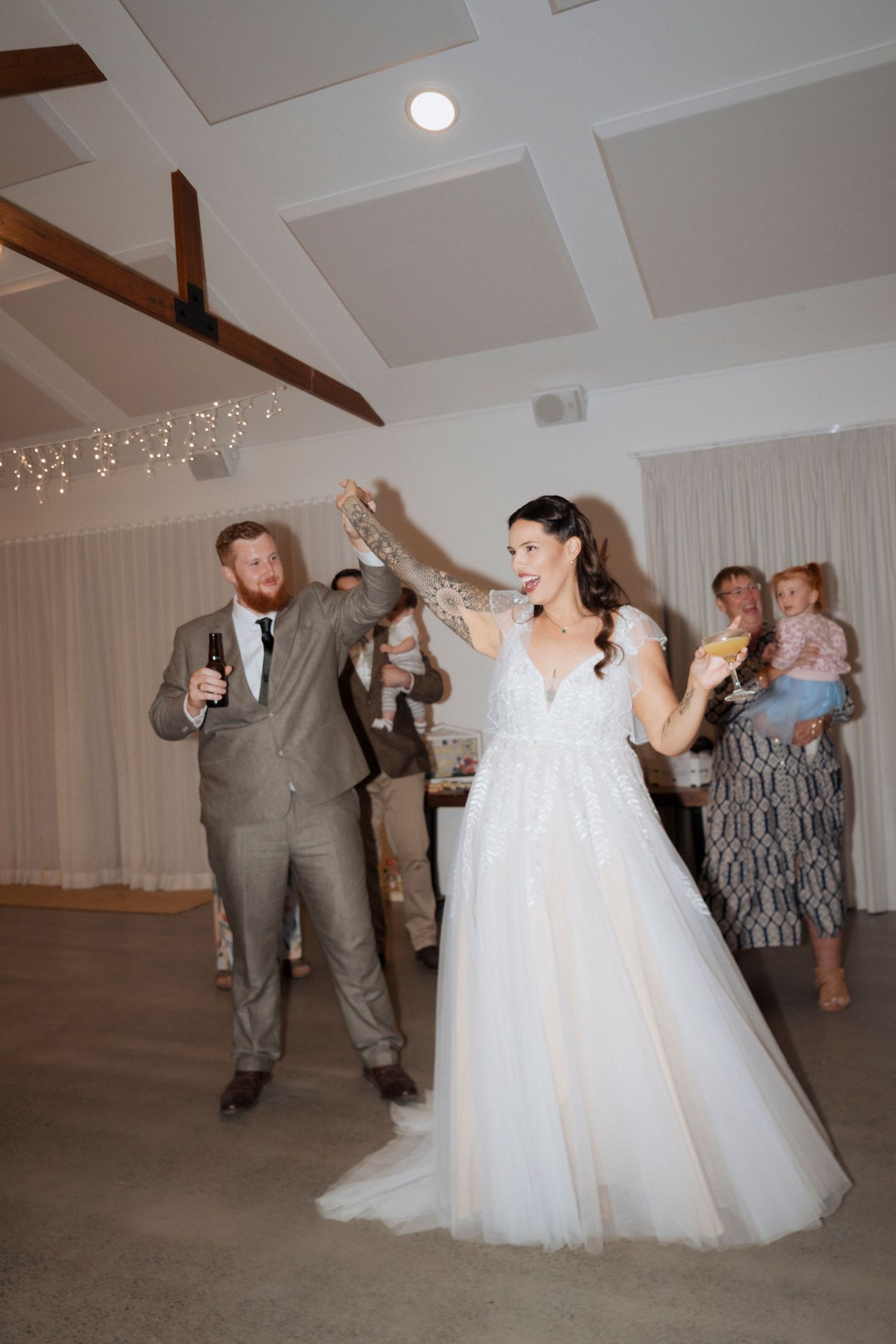 Bride and groom celebrating on the dance floor at Maroon Hill Estate reception.