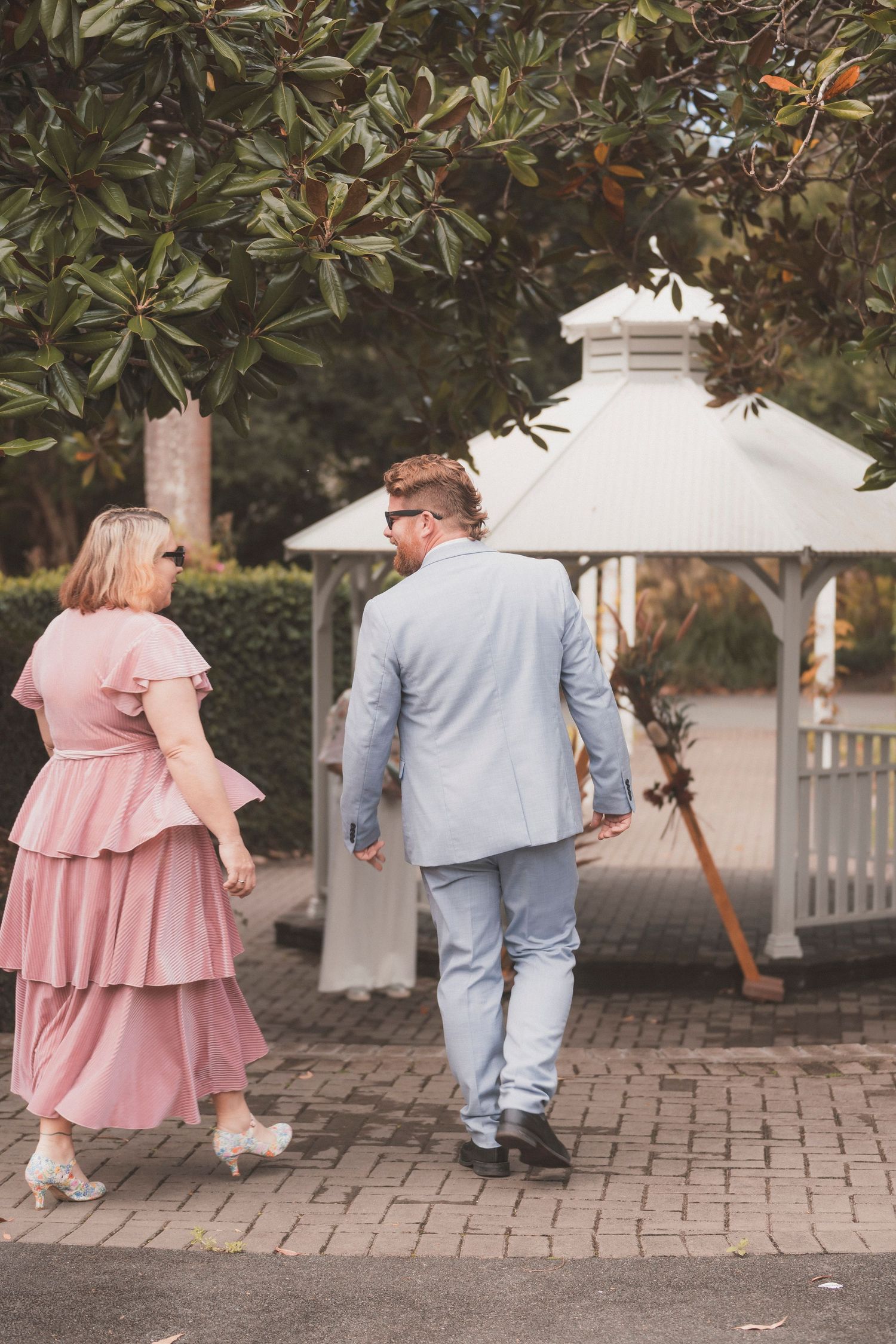 Bride and groom embracing during their surprise vow renewal at Noosa Botanical Gardens, captured by a Sunshine Coast documentary photographe