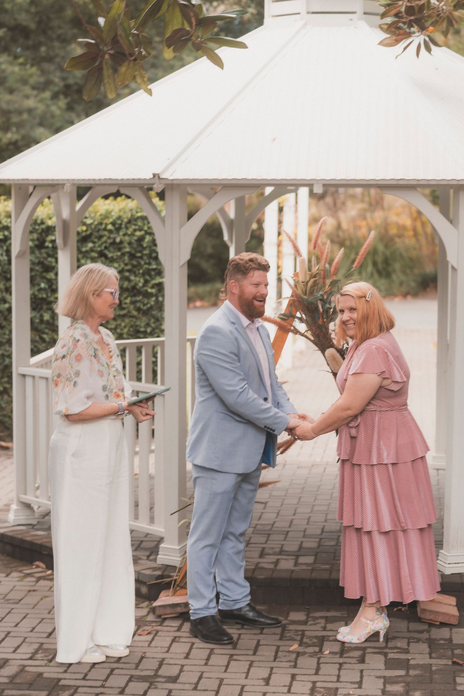Bride and groom embracing during their surprise vow renewal at Noosa Botanical Gardens, captured by a Sunshine Coast documentary photographe