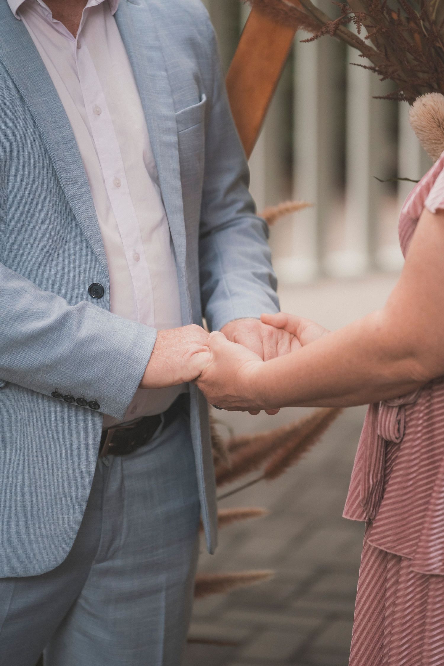 Bride and groom embracing during their surprise vow renewal at Noosa Botanical Gardens, captured by a Sunshine Coast documentary photographe