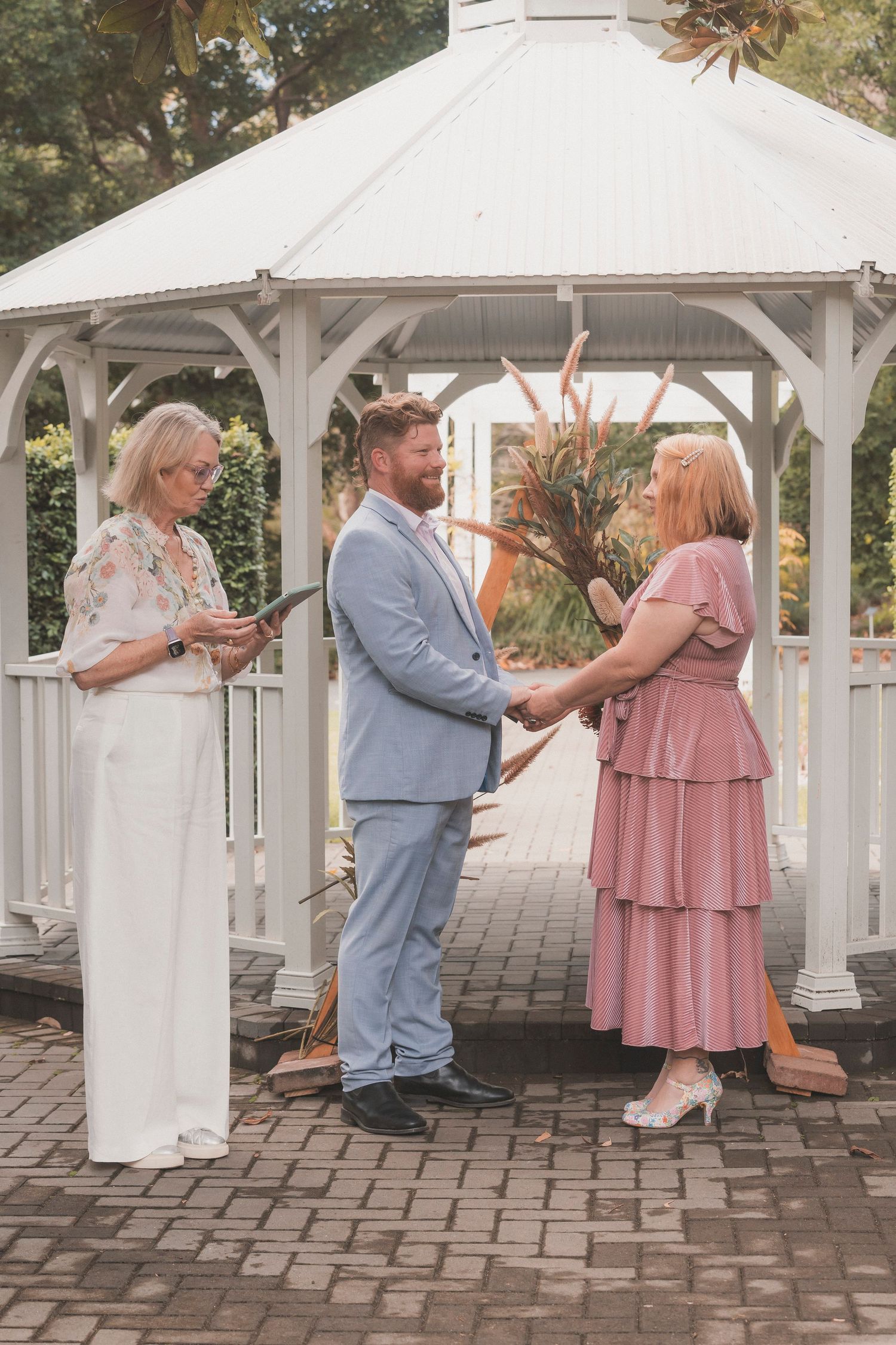 Bride and groom embracing during their surprise vow renewal at Noosa Botanical Gardens, captured by a Sunshine Coast documentary photographe