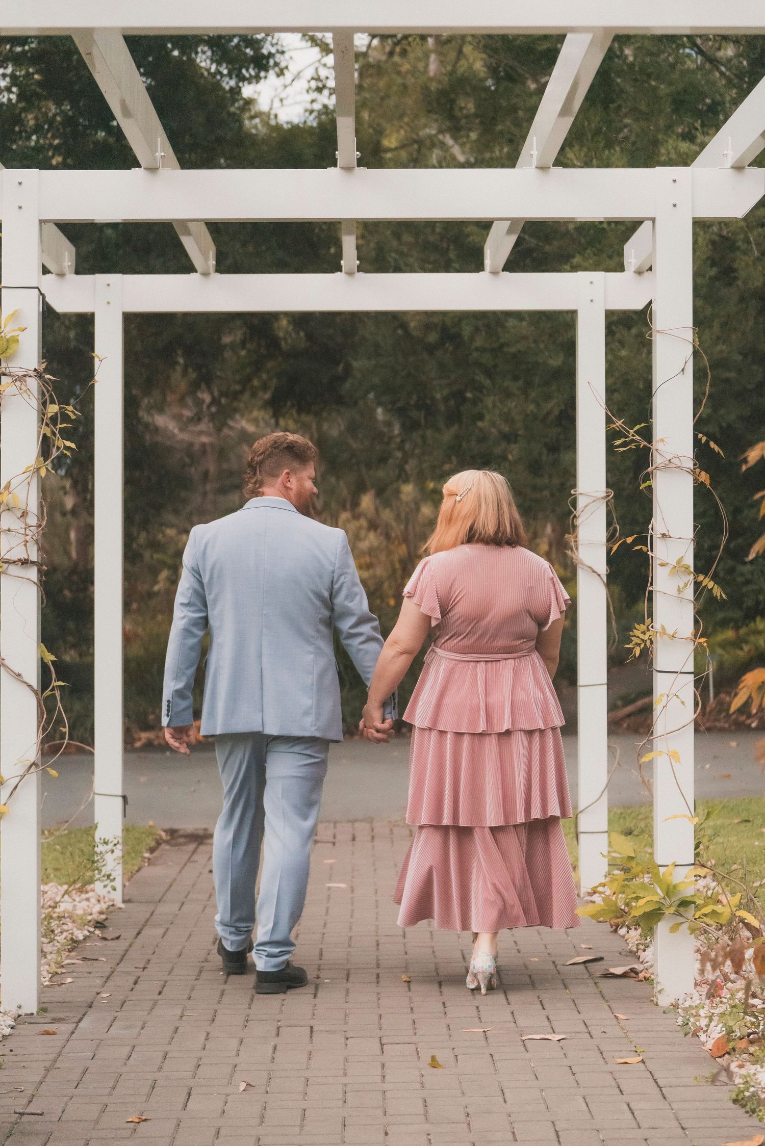 Couple exchanging vows during a 25 year anniversary vow renewal ceremony at Noosa Botanical Gardens, Sunshine Coast Queensland.