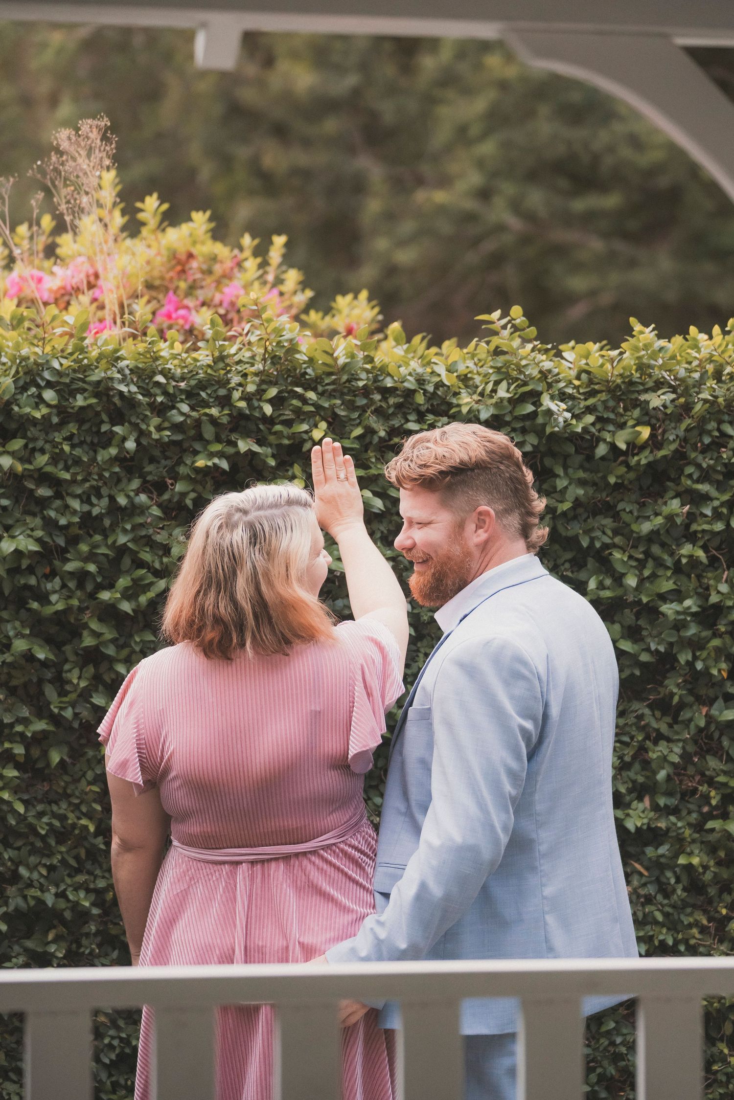 Couple exchanging vows during a 25 year anniversary vow renewal ceremony at Noosa Botanical Gardens, Sunshine Coast Queensland.