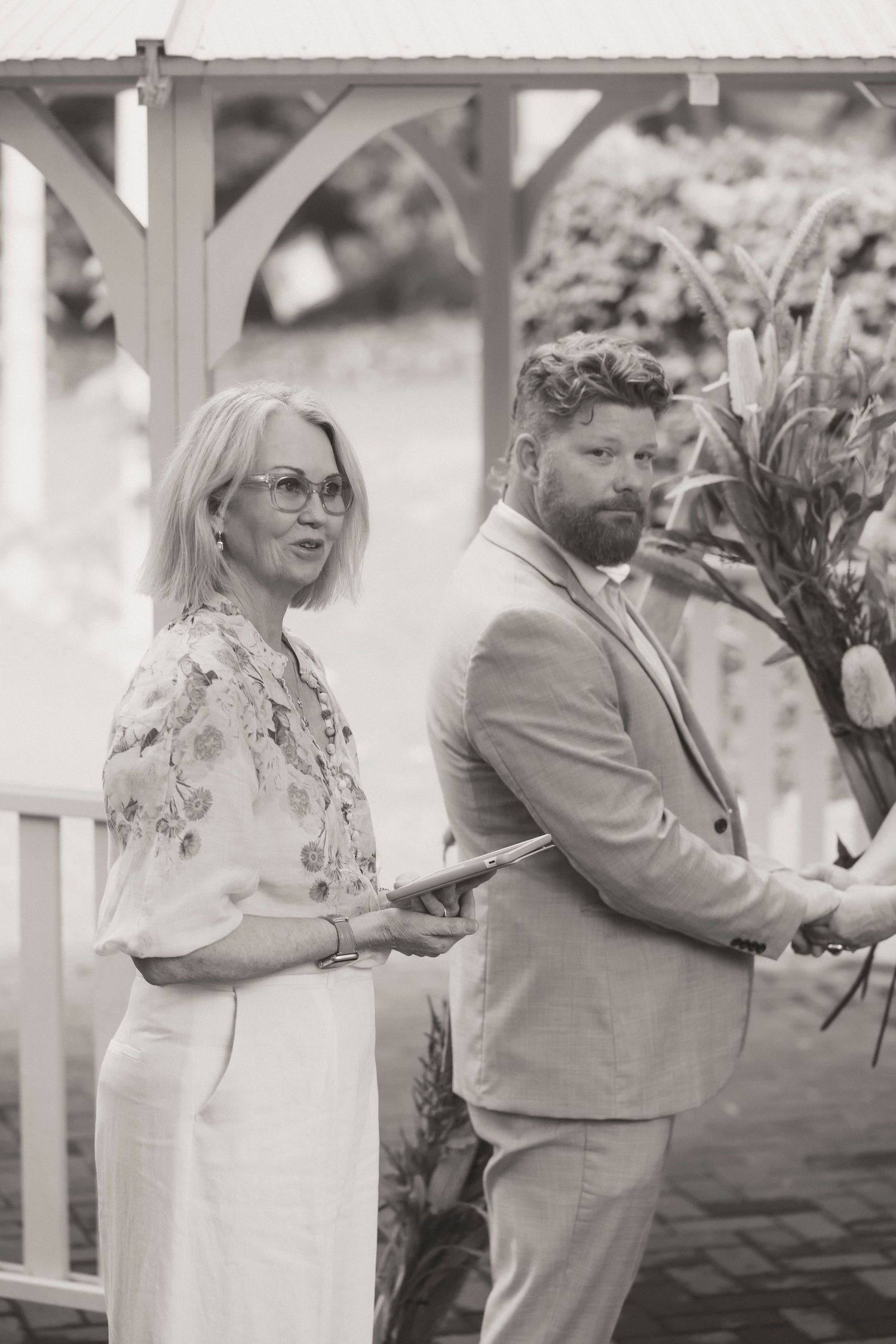 Couple exchanging vows during a 25 year anniversary vow renewal ceremony at Noosa Botanical Gardens, Sunshine Coast Queensland.