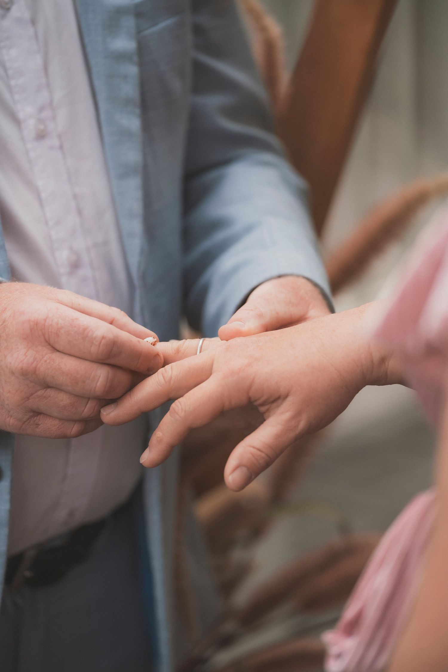 Bride and groom embracing during their surprise vow renewal at Noosa Botanical Gardens, captured by a Sunshine Coast documentary photographe