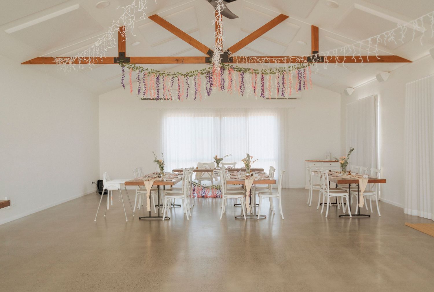 Reception styling inside Maroon Hill Estate with hanging florals and fairy lights.