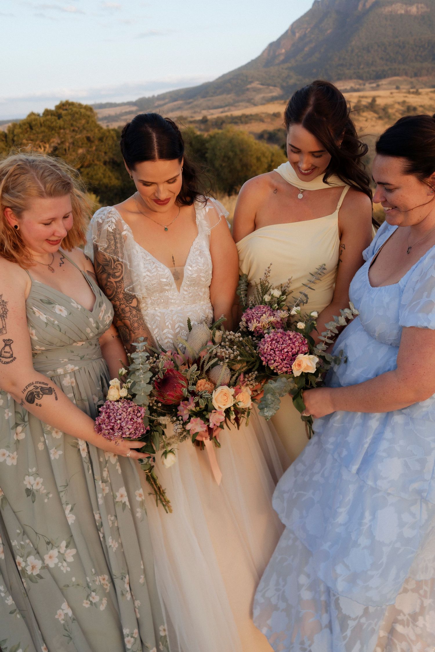 Bridal party laughing together on the expansive lawns at Maroon Hill Estate. pastel bridesmaids captured by editorial wedding photographer
