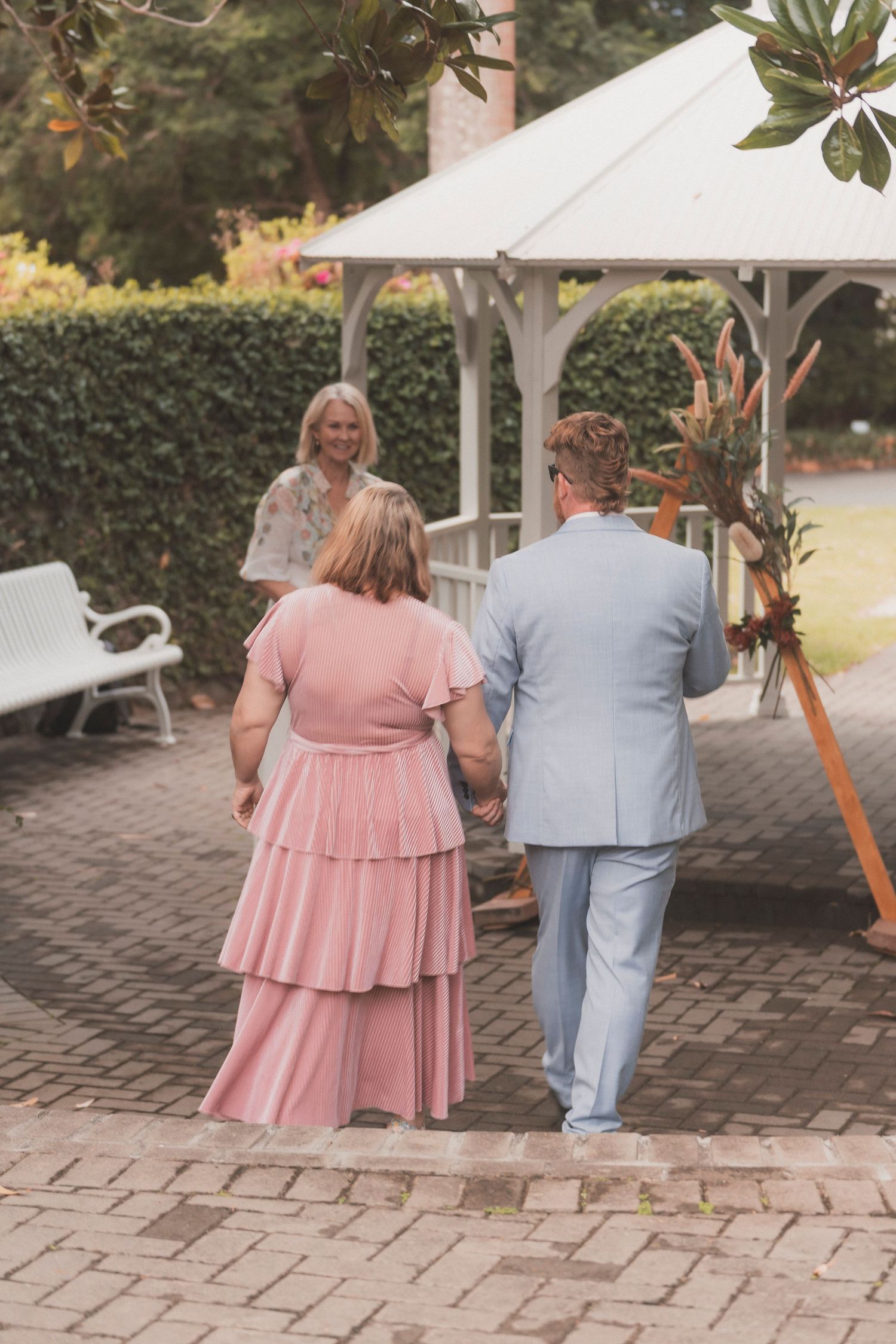 Bride and groom embracing during their surprise vow renewal at Noosa Botanical Gardens, captured by a Sunshine Coast documentary photographe