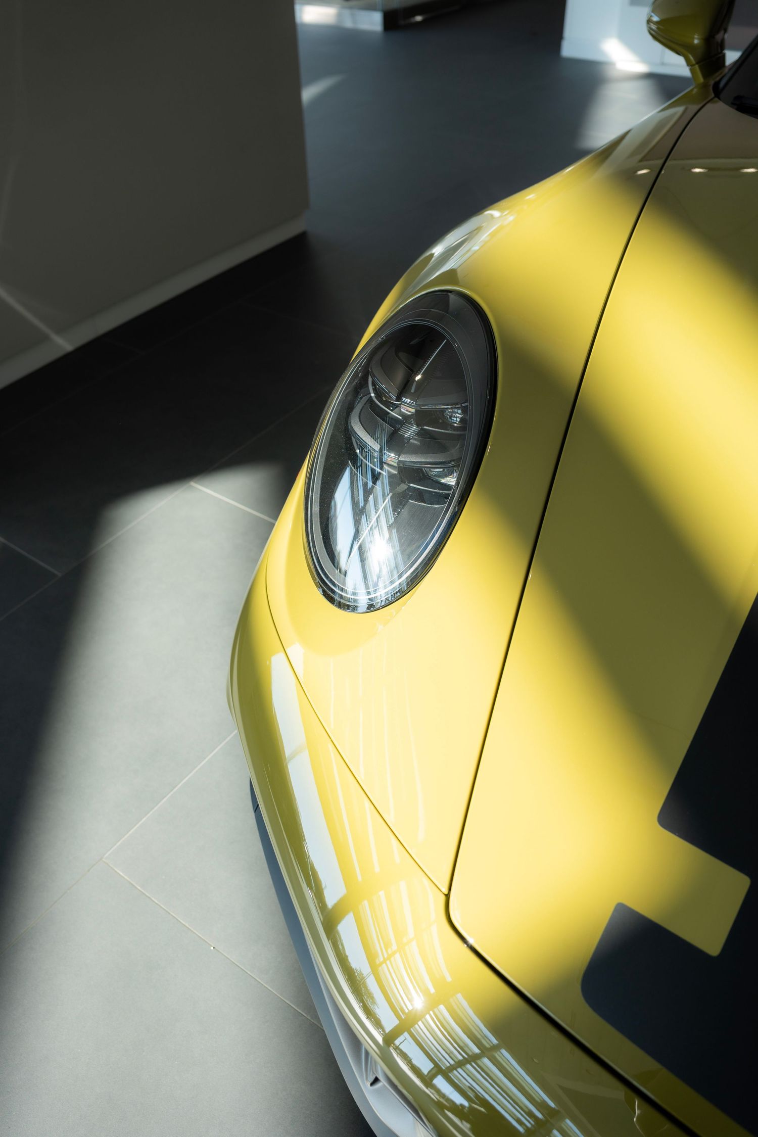 Creative composition framing a car through architectural or foreground elements for depth.