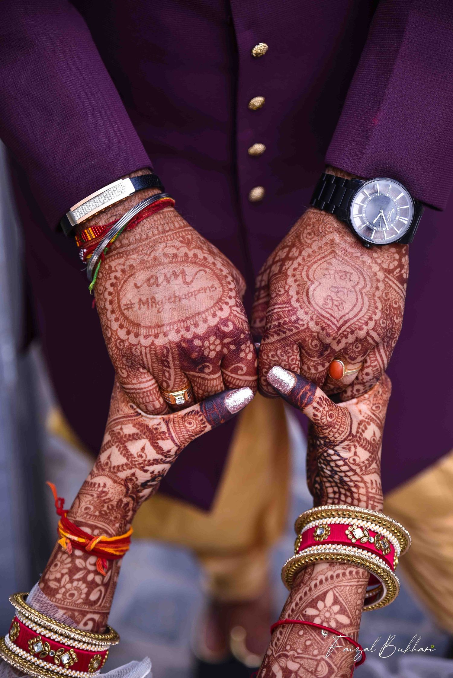 Intricate bridal mehndi henna designs on hands with gold bangles and a watch at an Indian wedding.