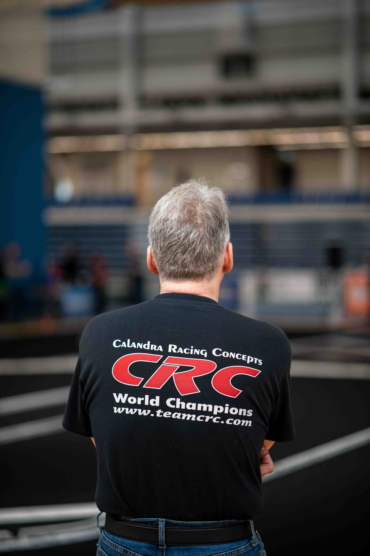 Man wearing a CRC Calandra Racing Concepts World Champions black t-shirt at an RC event.