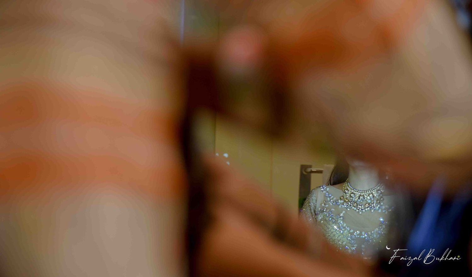 Artistic blurred reflection of a sparkling Indian bridal lehenga captured through a mirror during bridal prep.