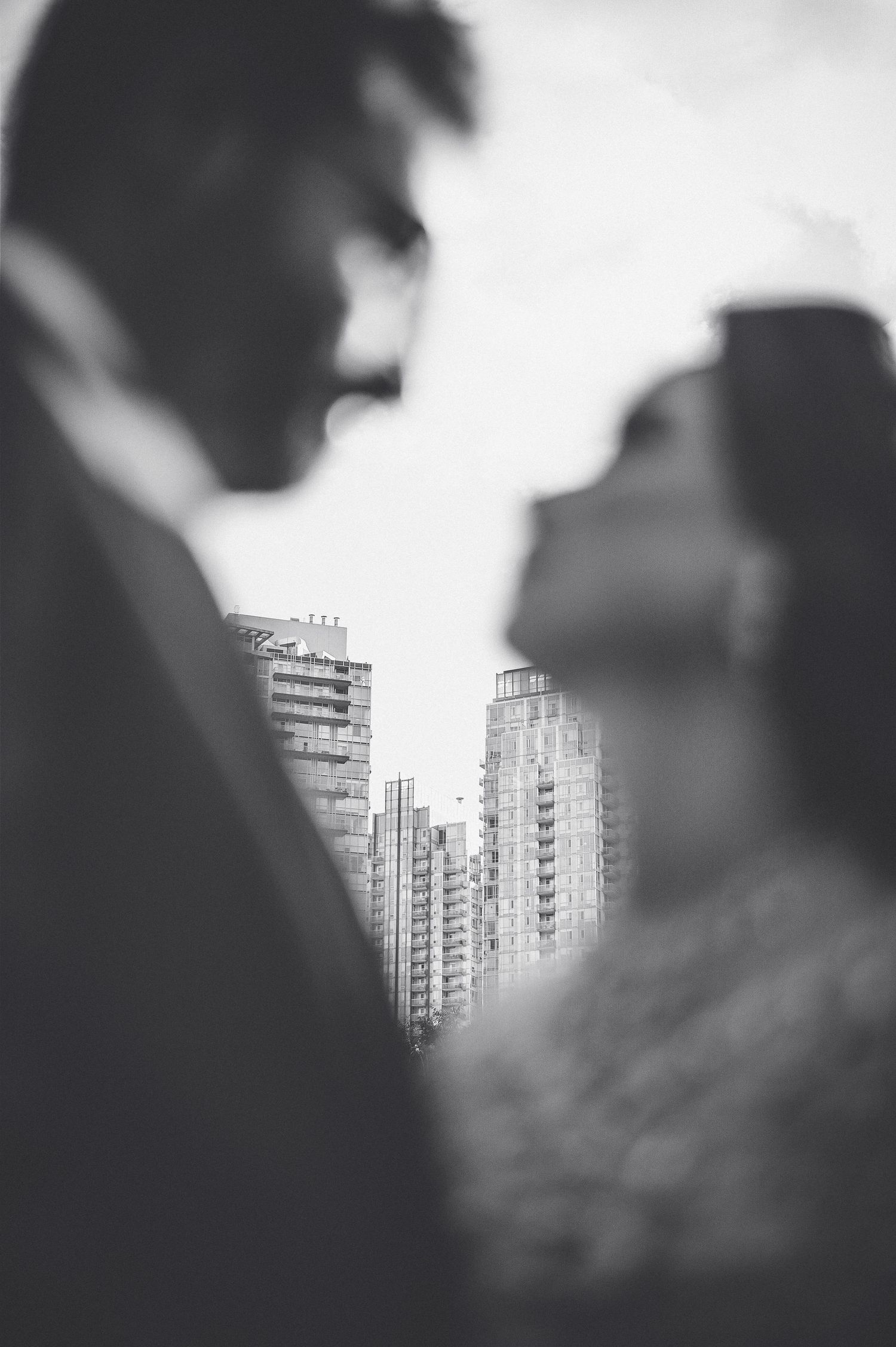 A couple in front of the toronto skyline. Shot by Faizal Bukhari a wedding photographer based in British Colombia. He does creative