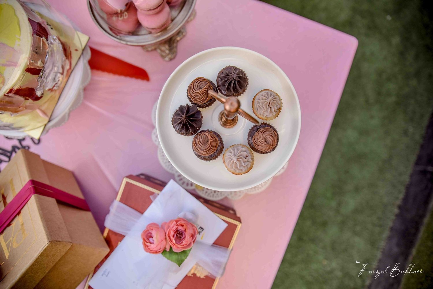 Overhead view of assorted chocolate bonbons and truffles on elegant white cake stand.