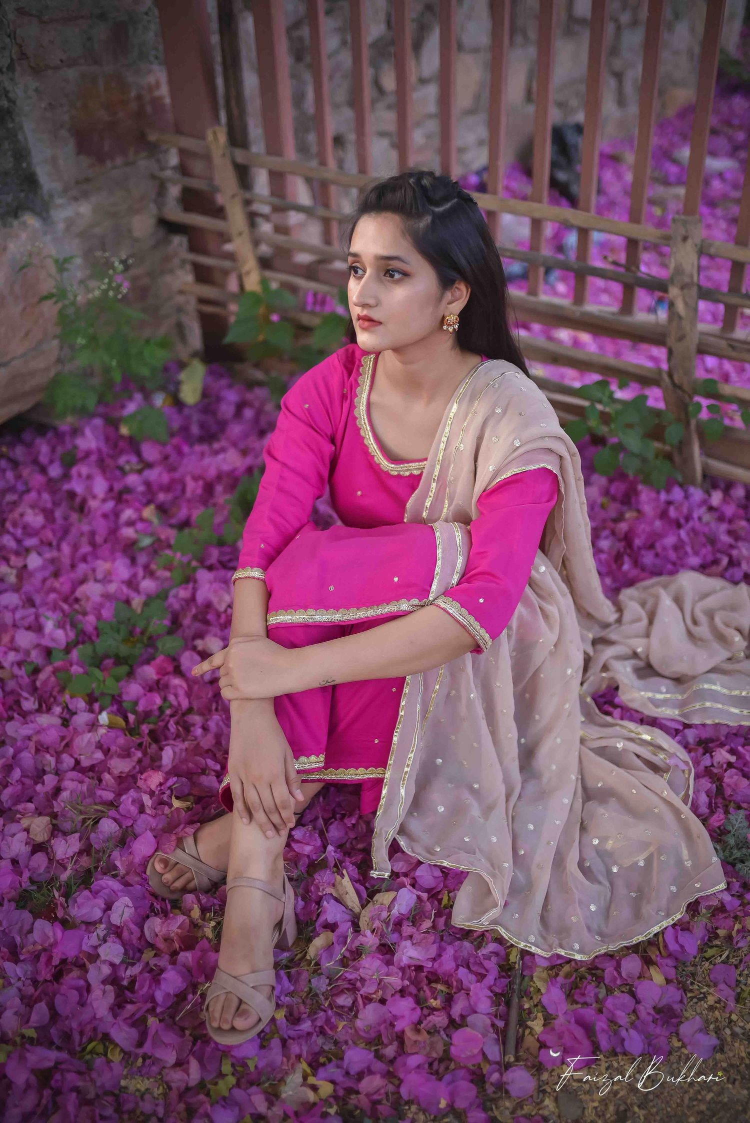 A pensive moment in pink. Sitting cross-legged on matching petals, a girl in South Asian dress reflects. Deeply soulful Kamloops imagery.