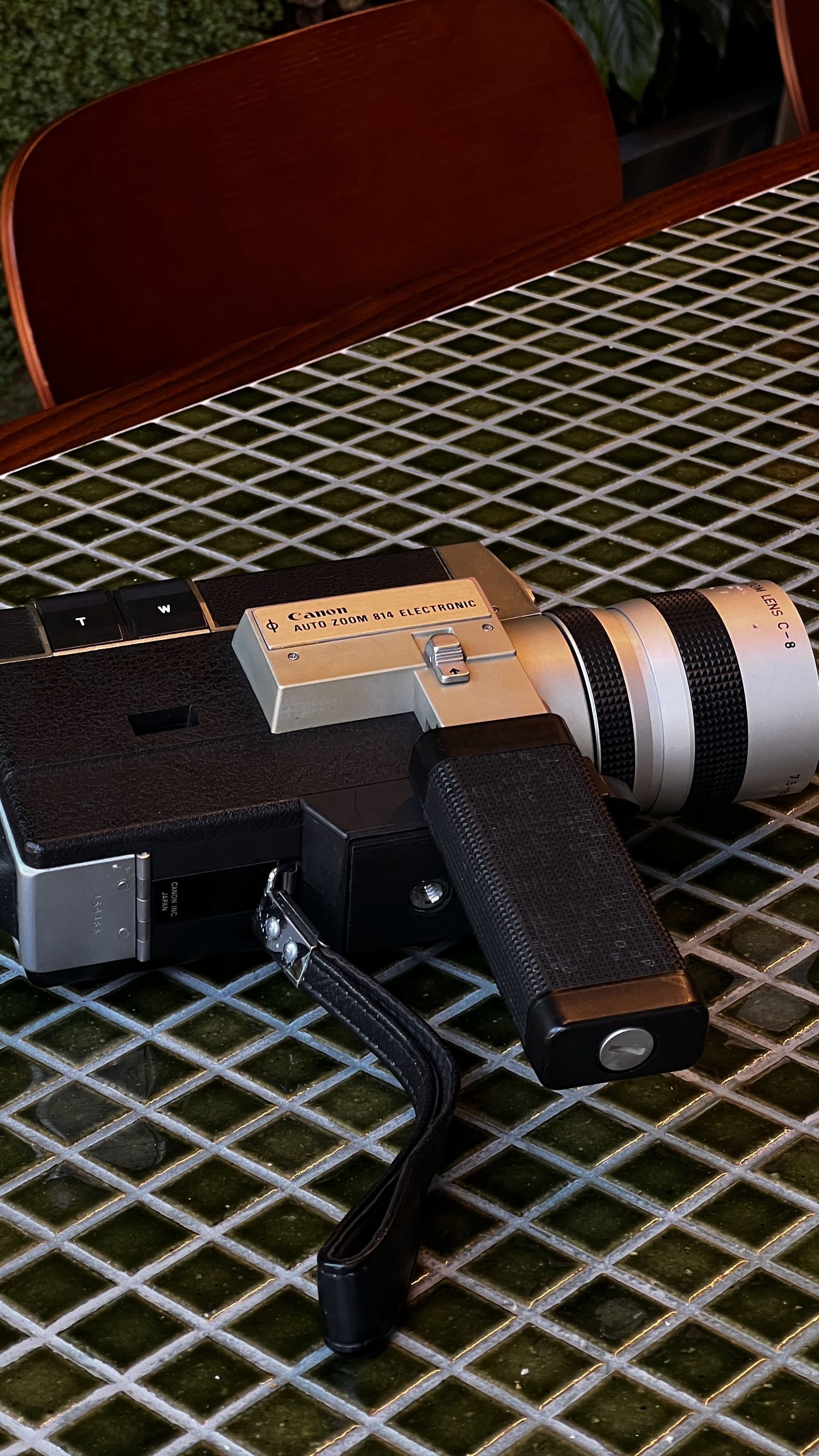 Professional camera lens and equipment mounted on a metal grid surface.