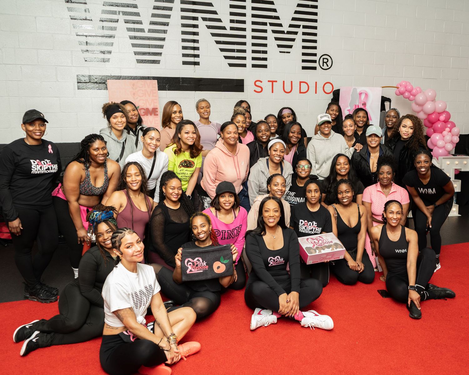 Empowerment and wellness event in Atlanta, Georgia — group of black women gathered at WNM Studio for a fitness and community celebration.