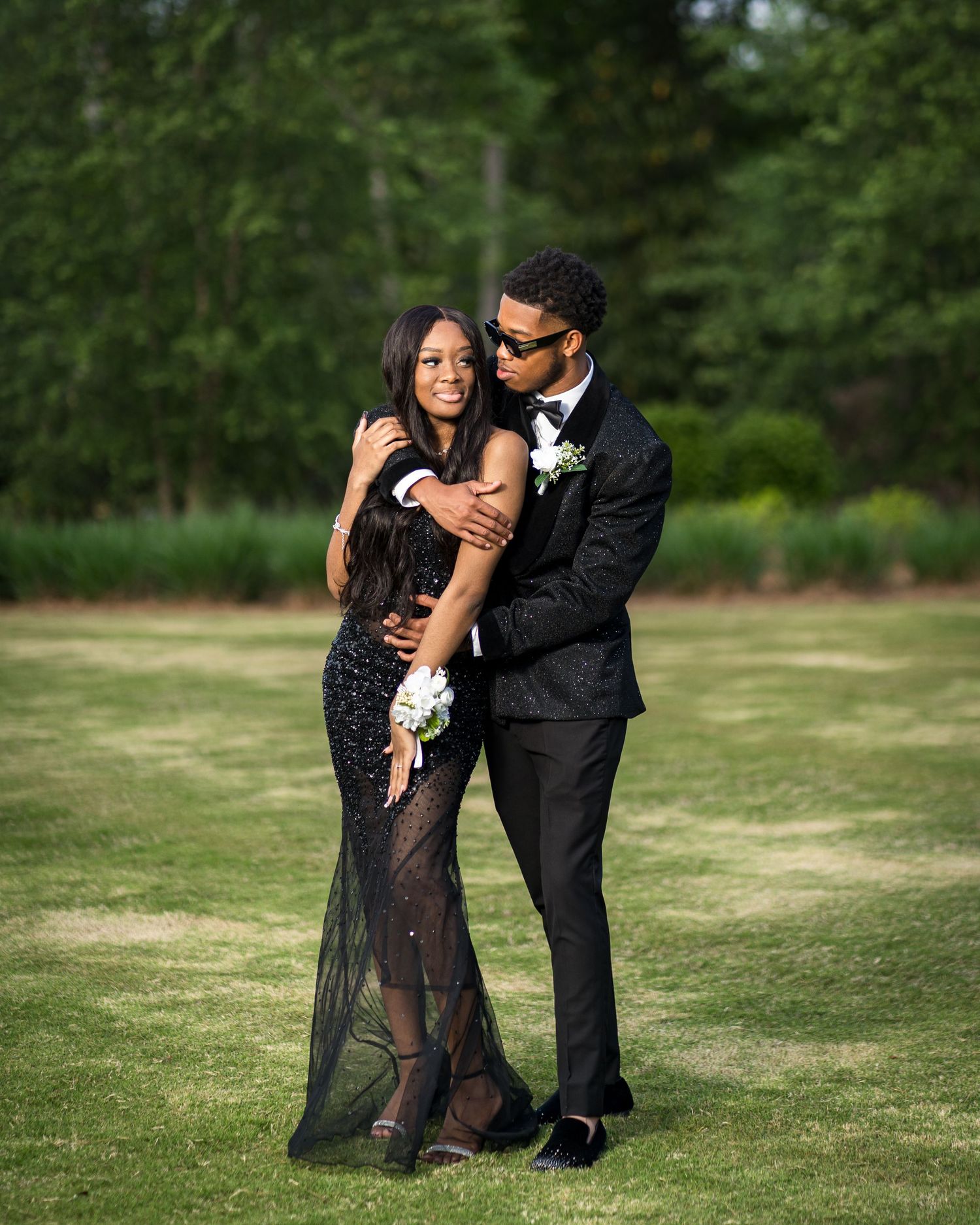Young Black couple in black-tie attire posing for prom portraits at Trilith Park in Atlanta.