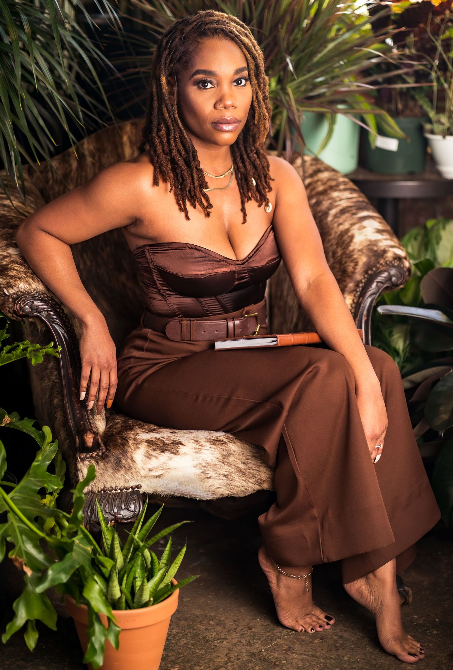 Natural beauty portrait of Black woman with locs in botanical setting, photographed in Atlanta.