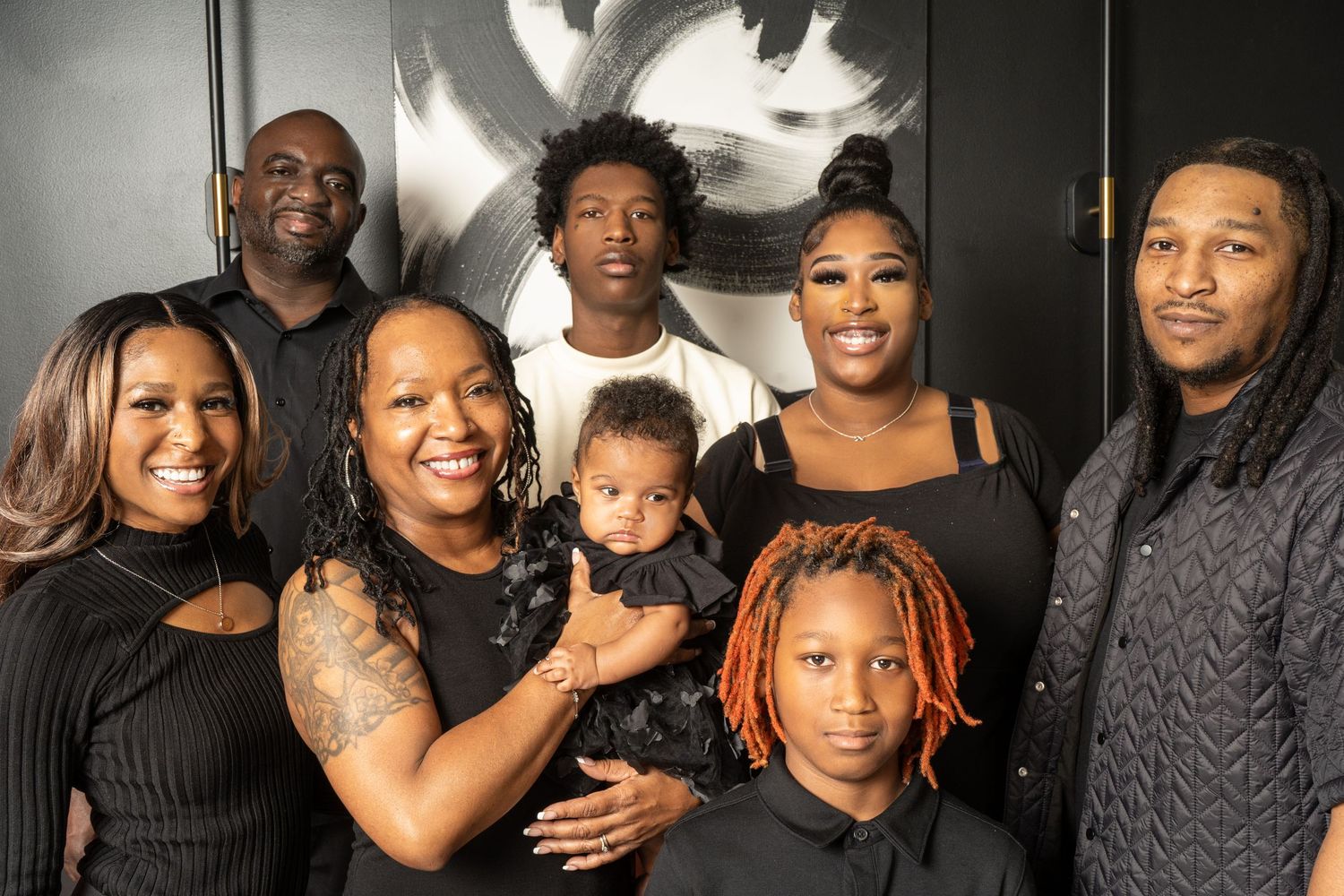 Black Family portrait session in Marietta, Georgia — three-generation family dressed in coordinating black outfits during a studio shoot.