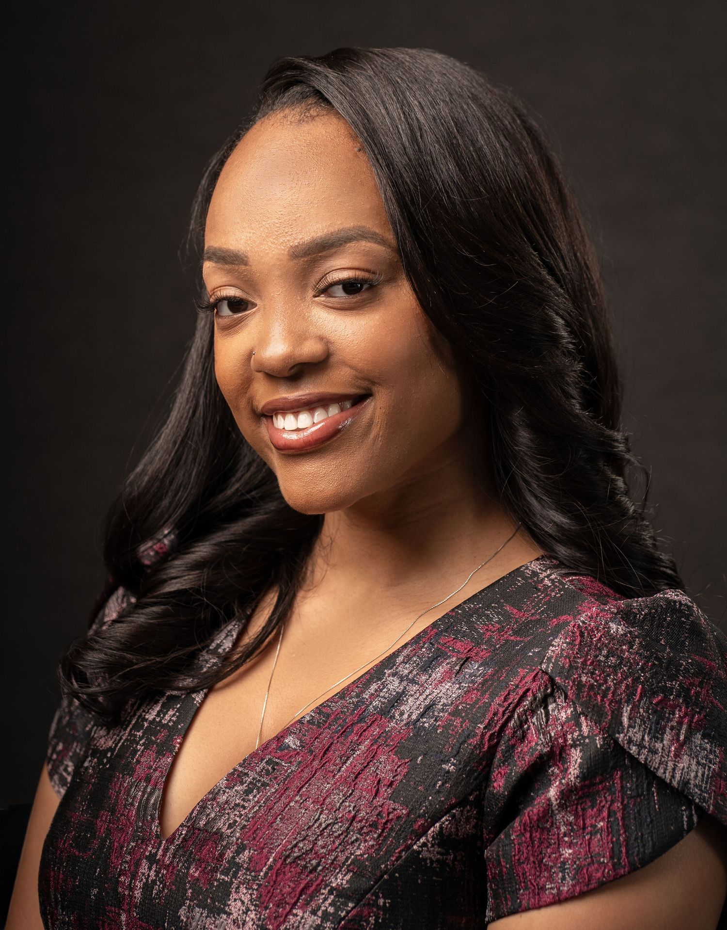 Professional headshot in Marietta, Georgia — confident black woman smiling softly in studio lighting, perfect for branding or LinkedIn.