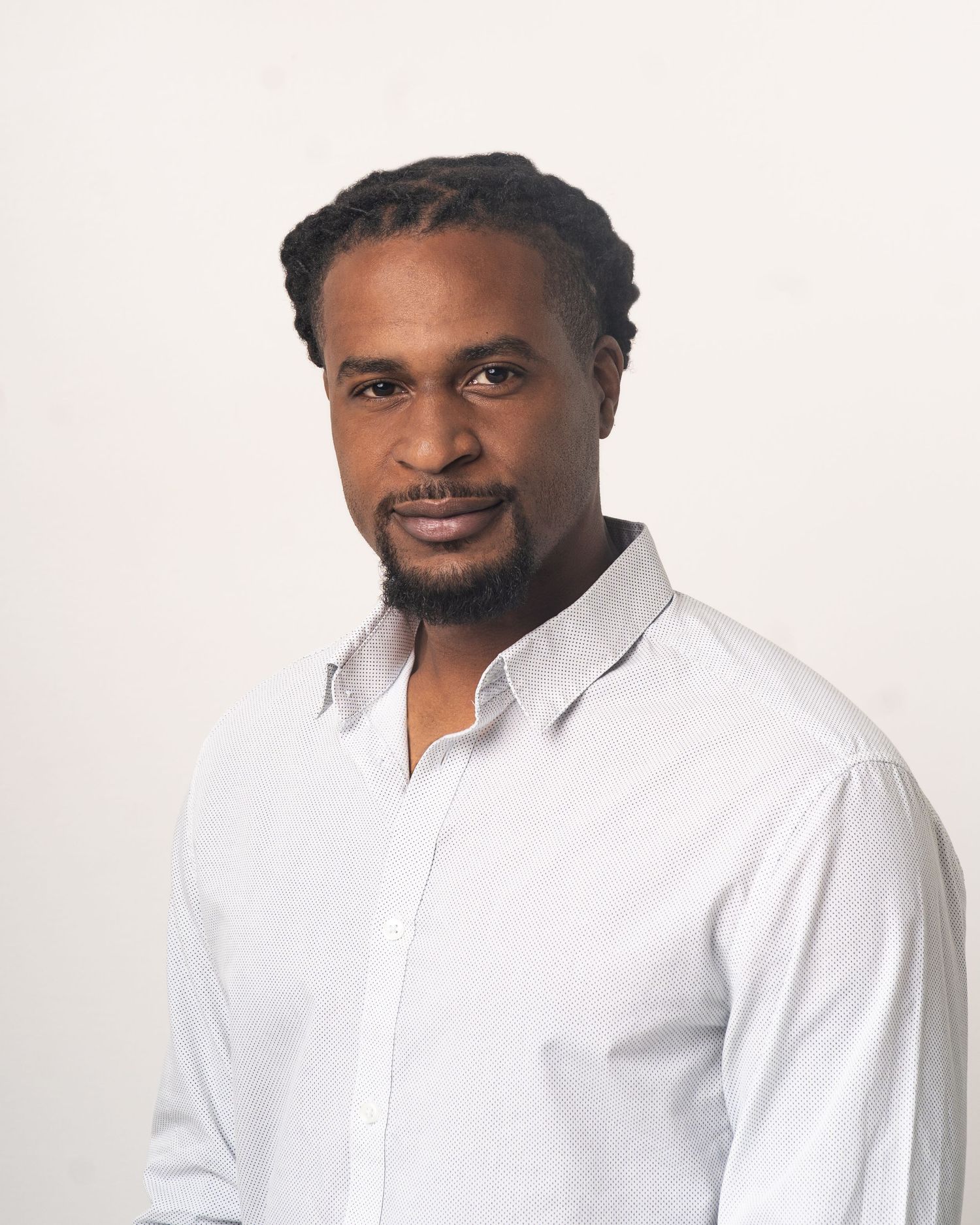 Confident, polished headshot of a Black man captured in studio lighting — ideal for LinkedIn and professional branding.
