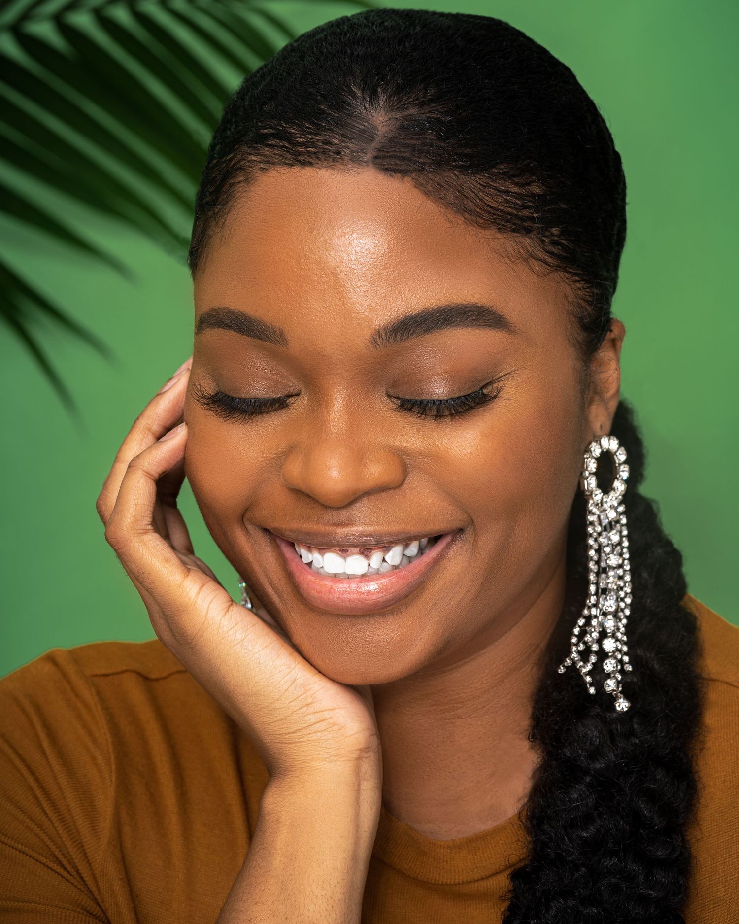 Professional headshot session in Vinings, Georgia — close-up portrait of a woman smiling gracefully against a green backdrop, showcasing nat