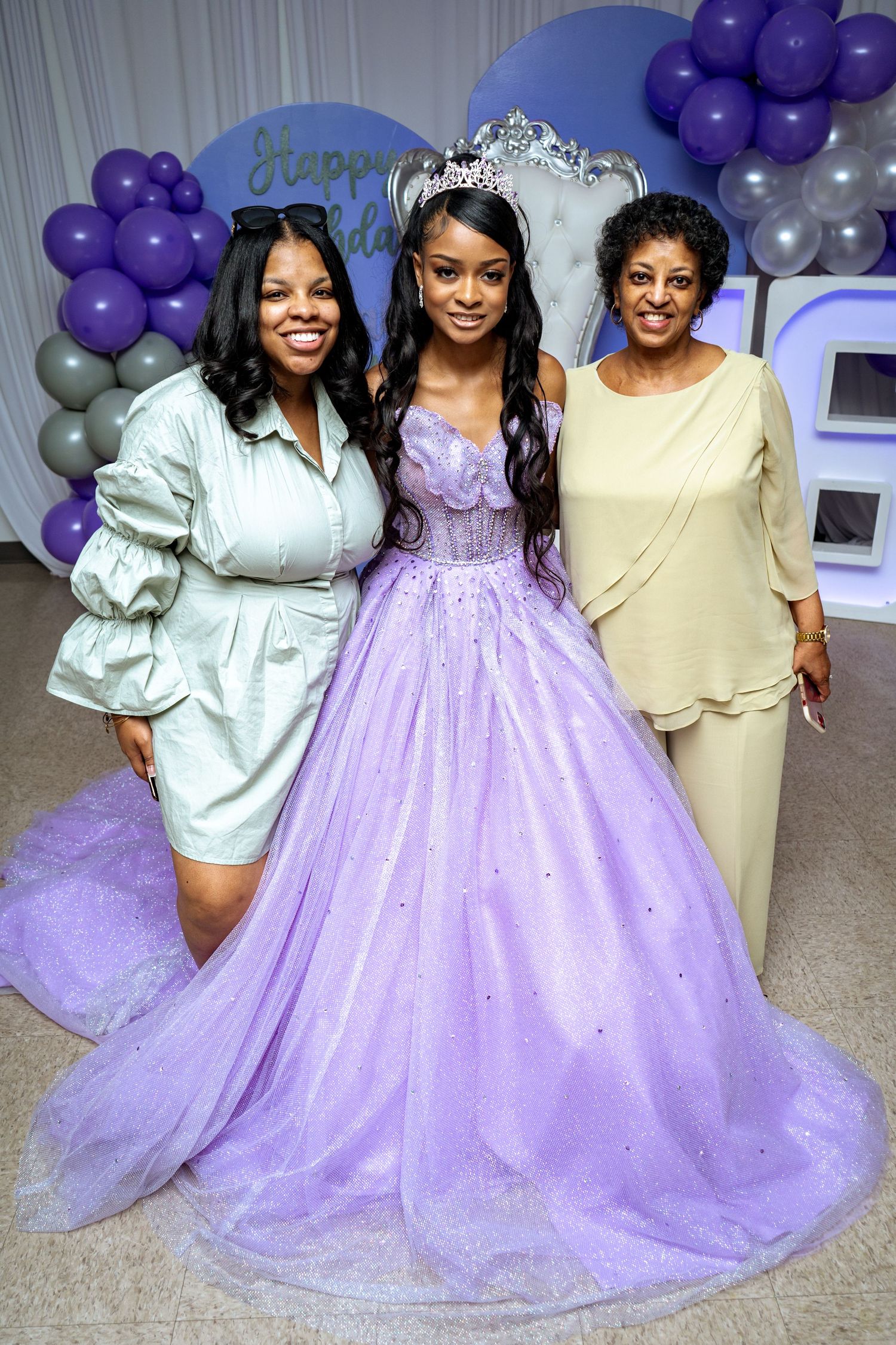 Sweet sixteen celebration in Smyrna, Georgia — birthday girl in a lavender gown with family members posing proudly at her event.