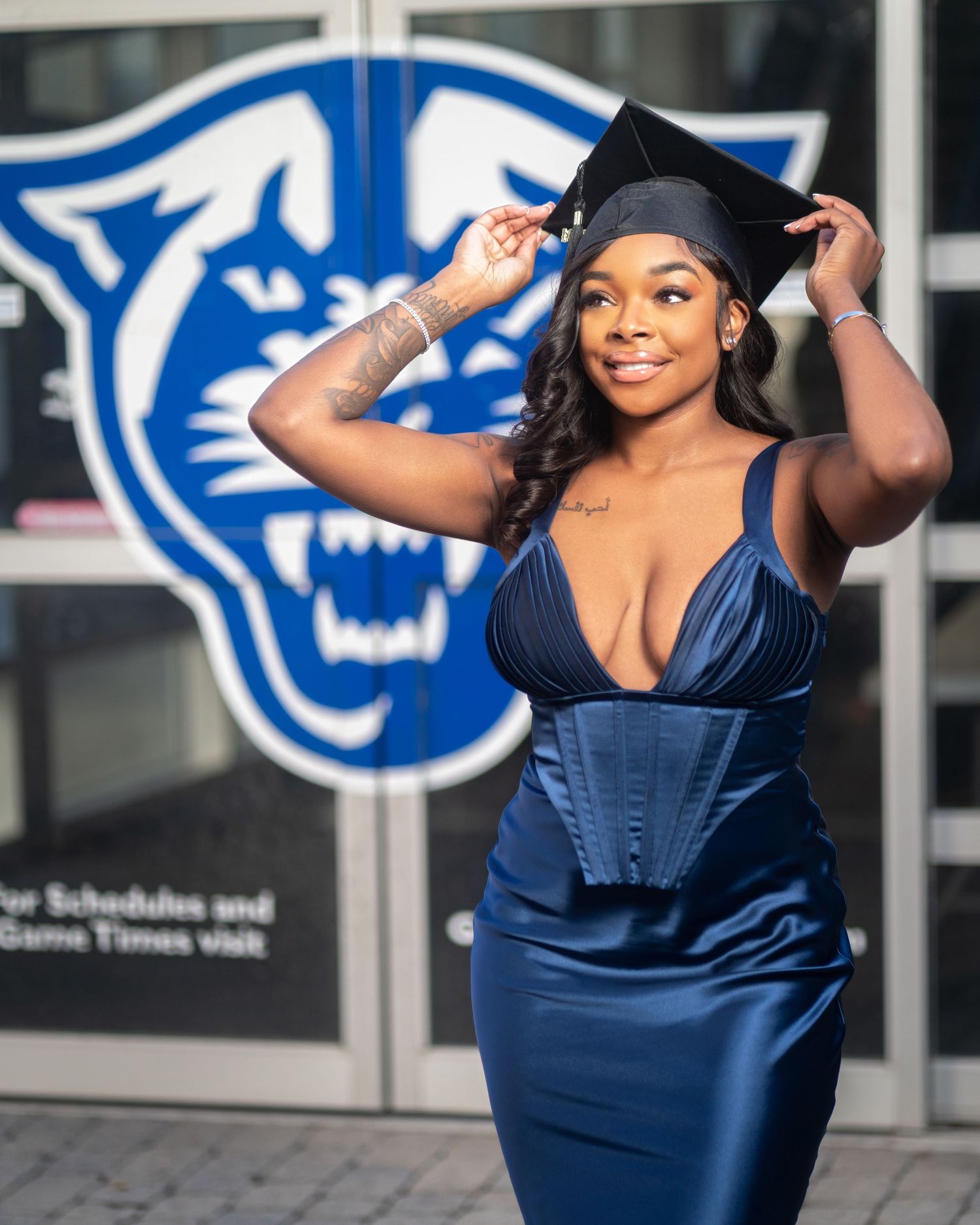 College graduate posing in cap and gown during golden hour in Atlanta at Spelman University
