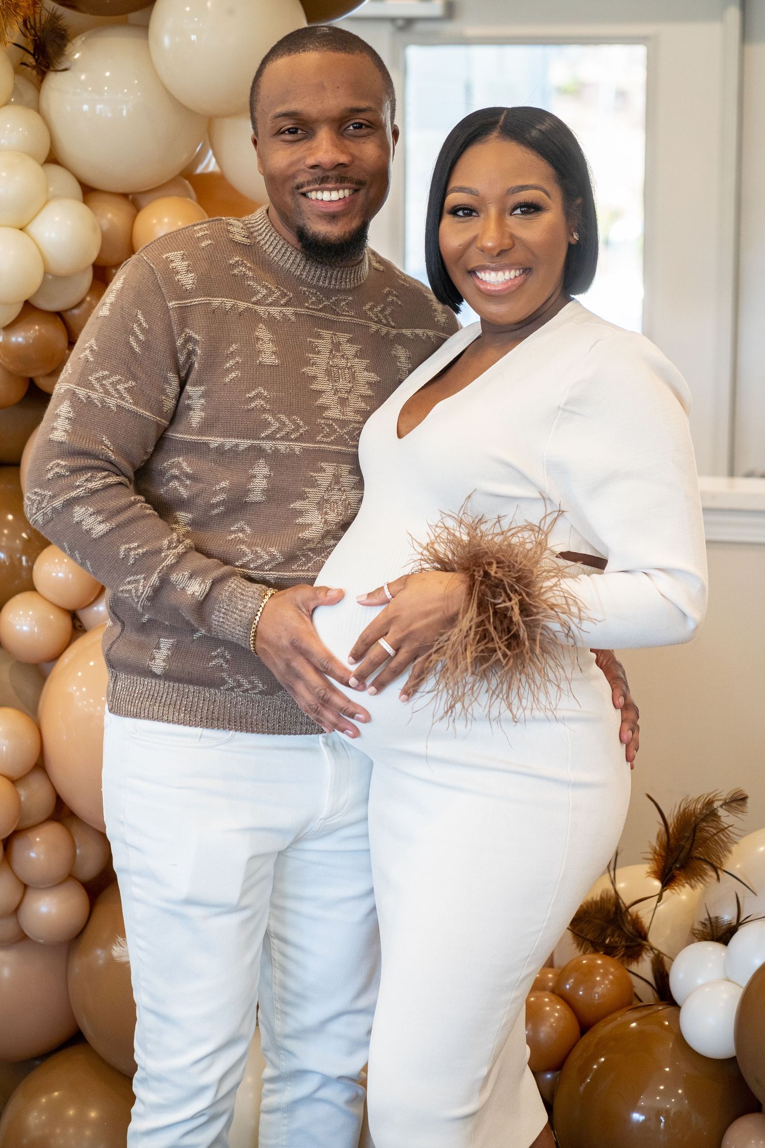 Studio maternity photo session in Roswell, Georgia — expectant couple posing together in coordinating neutral tones