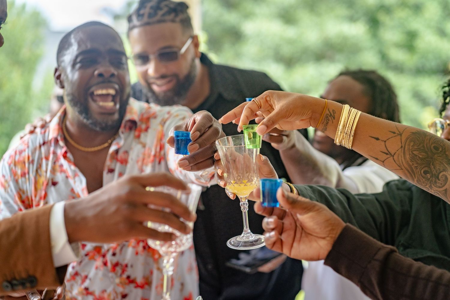 Candid celebration photo in Smyrna, Georgia — friends sharing laughter and raising glasses during an outdoor gathering.