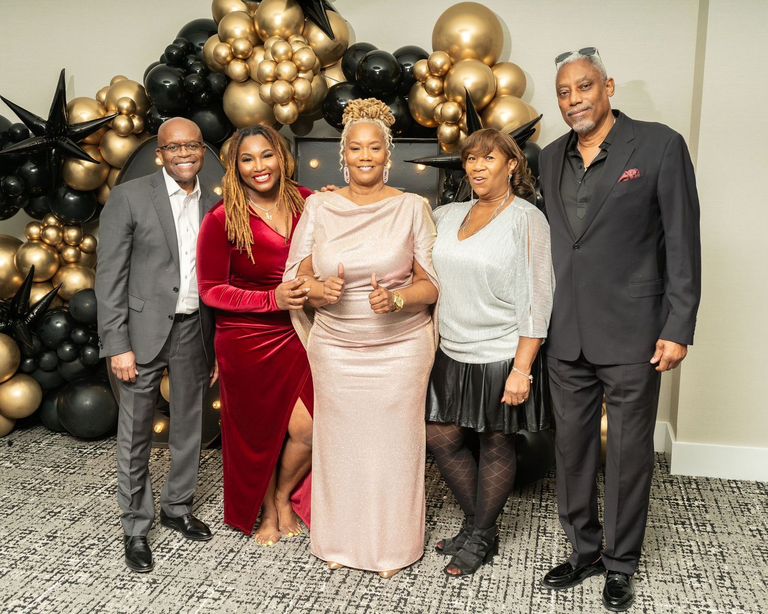 Family and friends pose for a photo for a 65th birthday party, captured by Murray Vision Photography