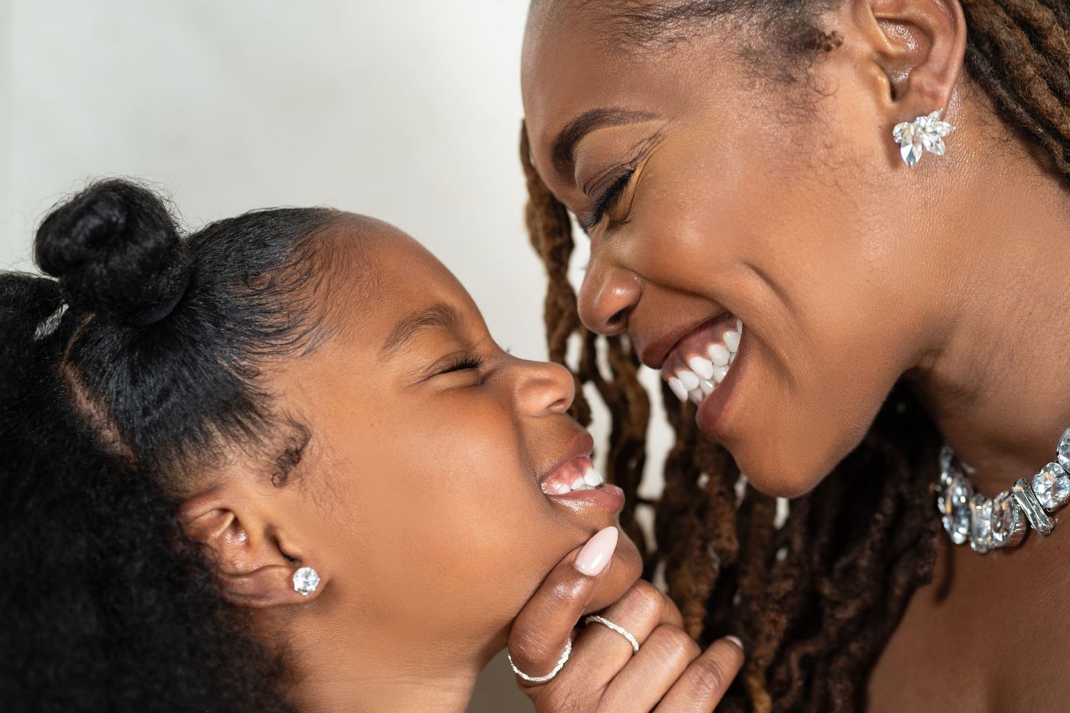 A black mother and daughter share a heartfelt moment during a photoshoot in Atlanta