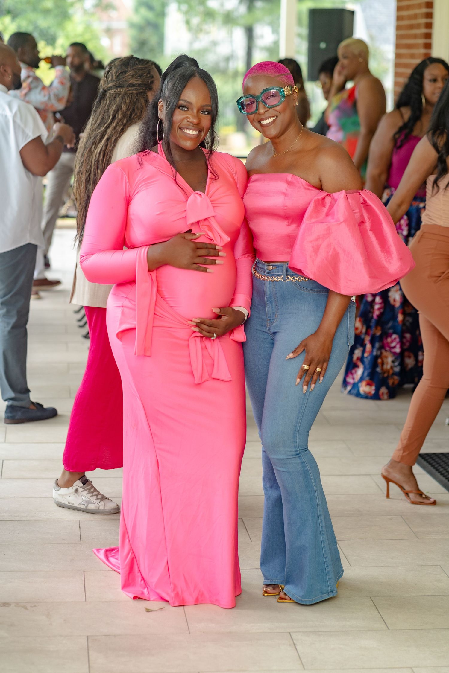Two black women in pink outfits posing together at a baby shower event in Atlanta, Georgia near Vinings, Ga