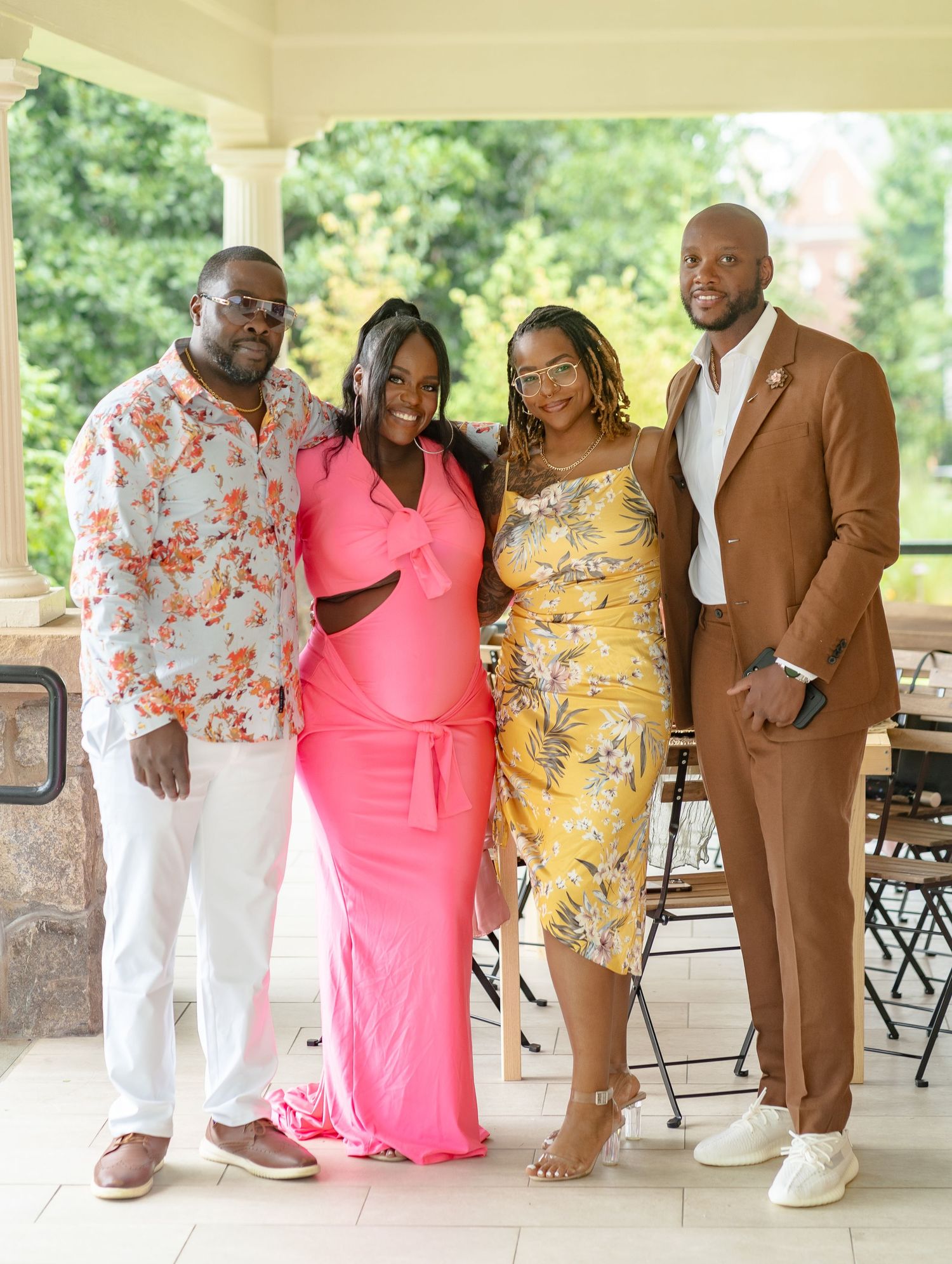 Two couples posing together during a joyful baby shower celebration in Smyrna, GA