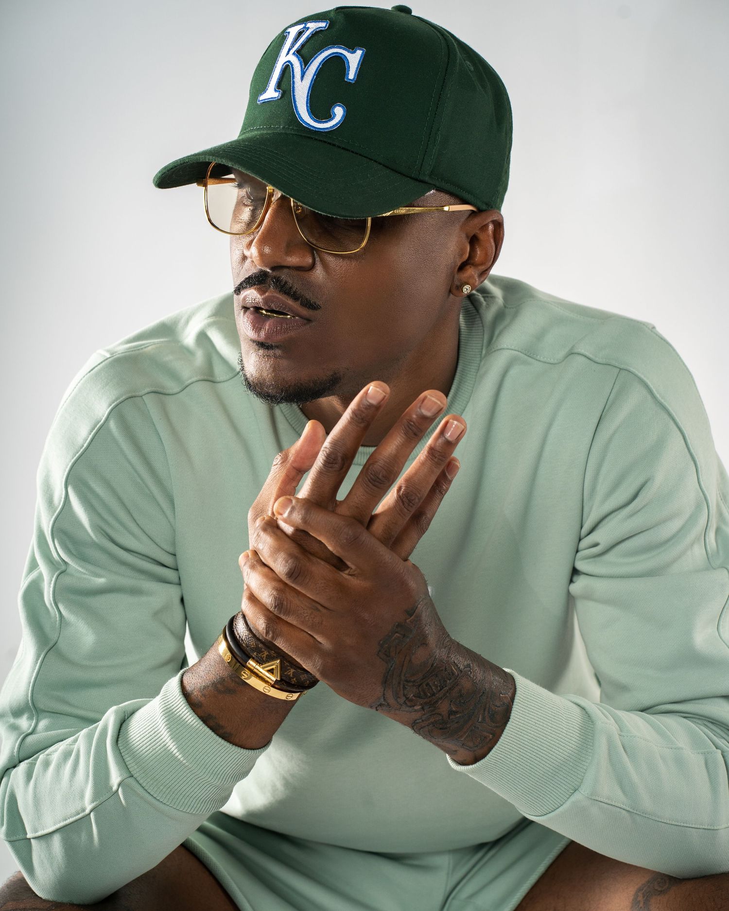 Bold studio portrait featuring a tattooed Black man on a white backdrop — shot in a studio in Marietta.