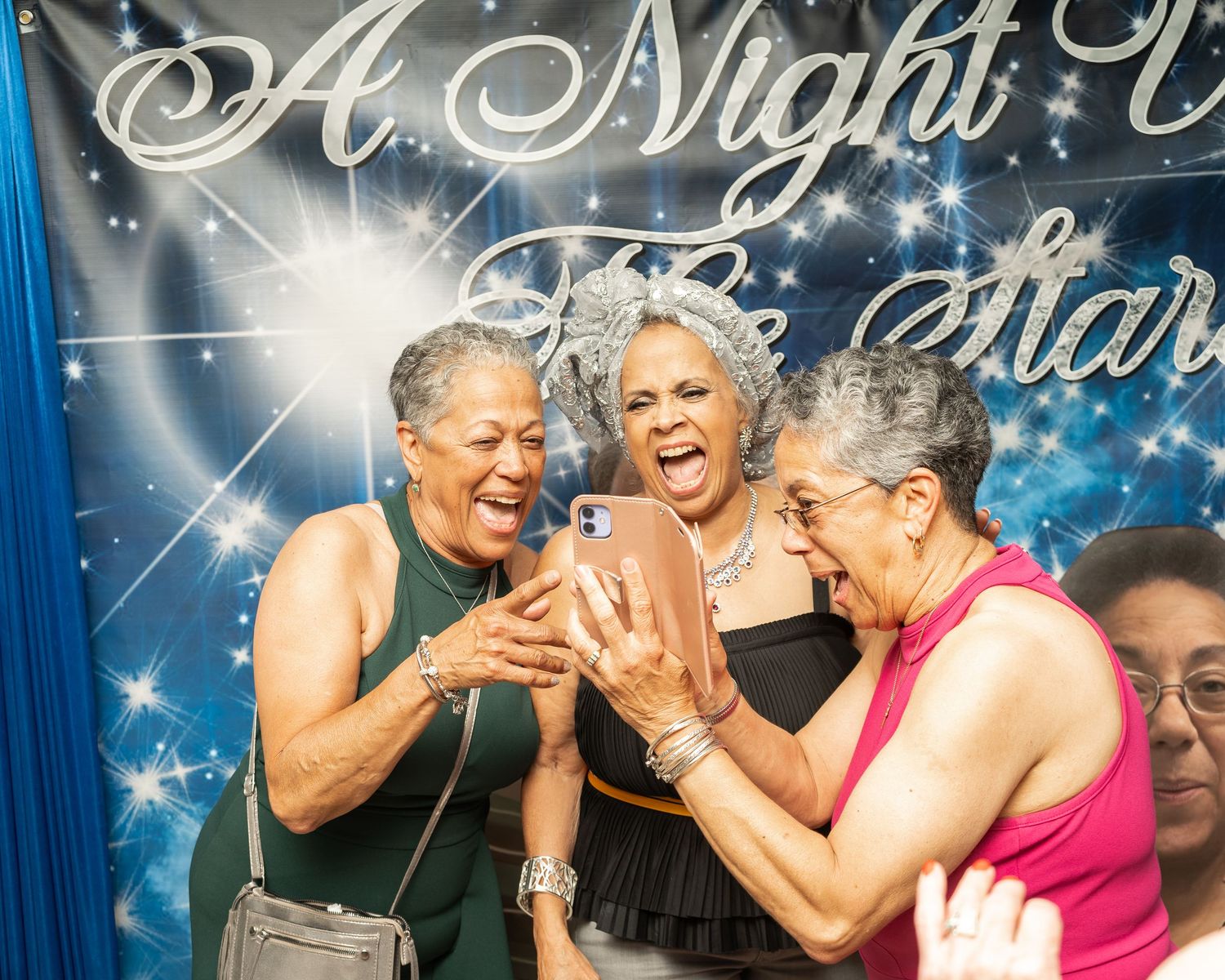 Candid photo of three women laughing together at a “Night Under the Stars” event in Mableton, Georgia.